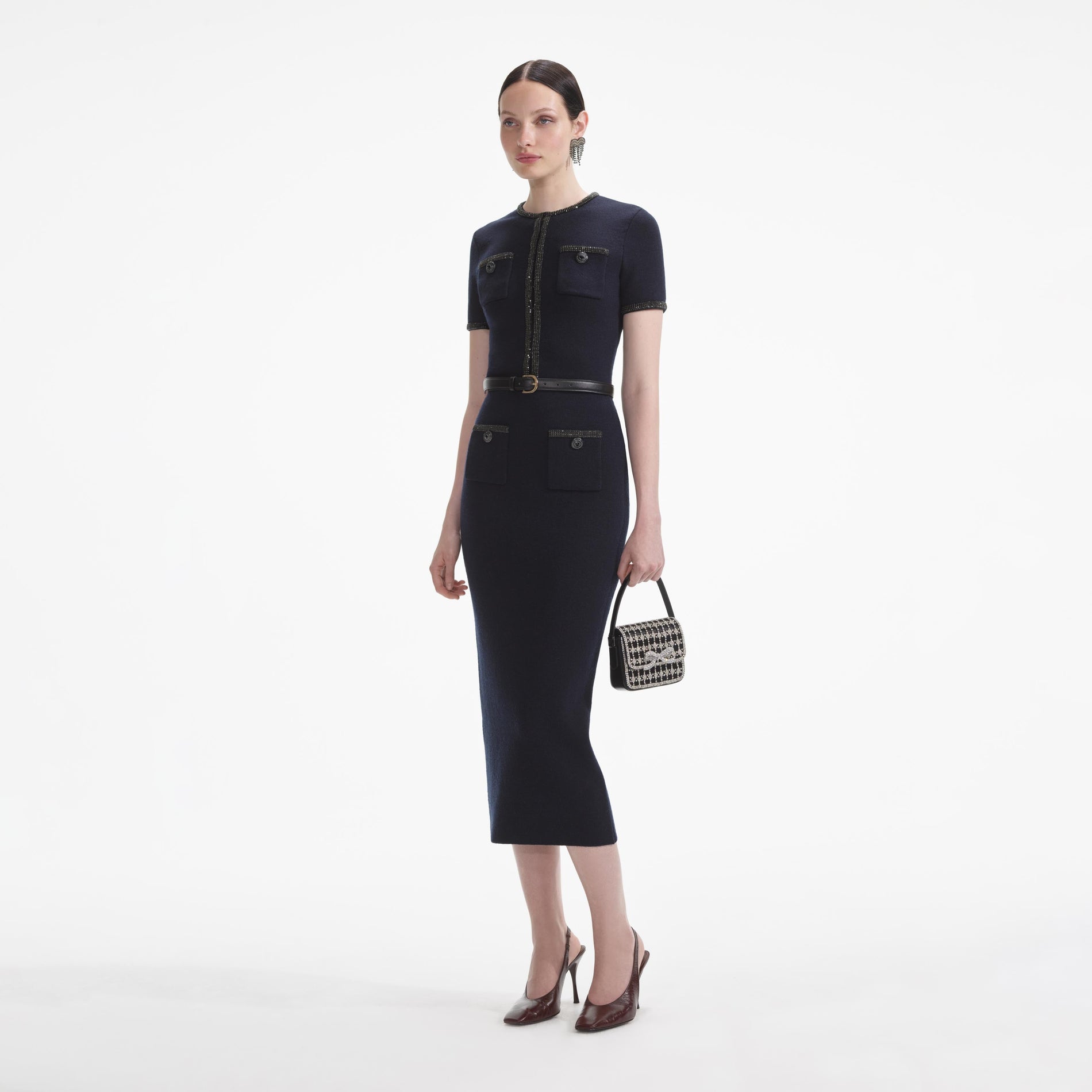 Side view of a woman wearing the Navy Embellished Knit Top