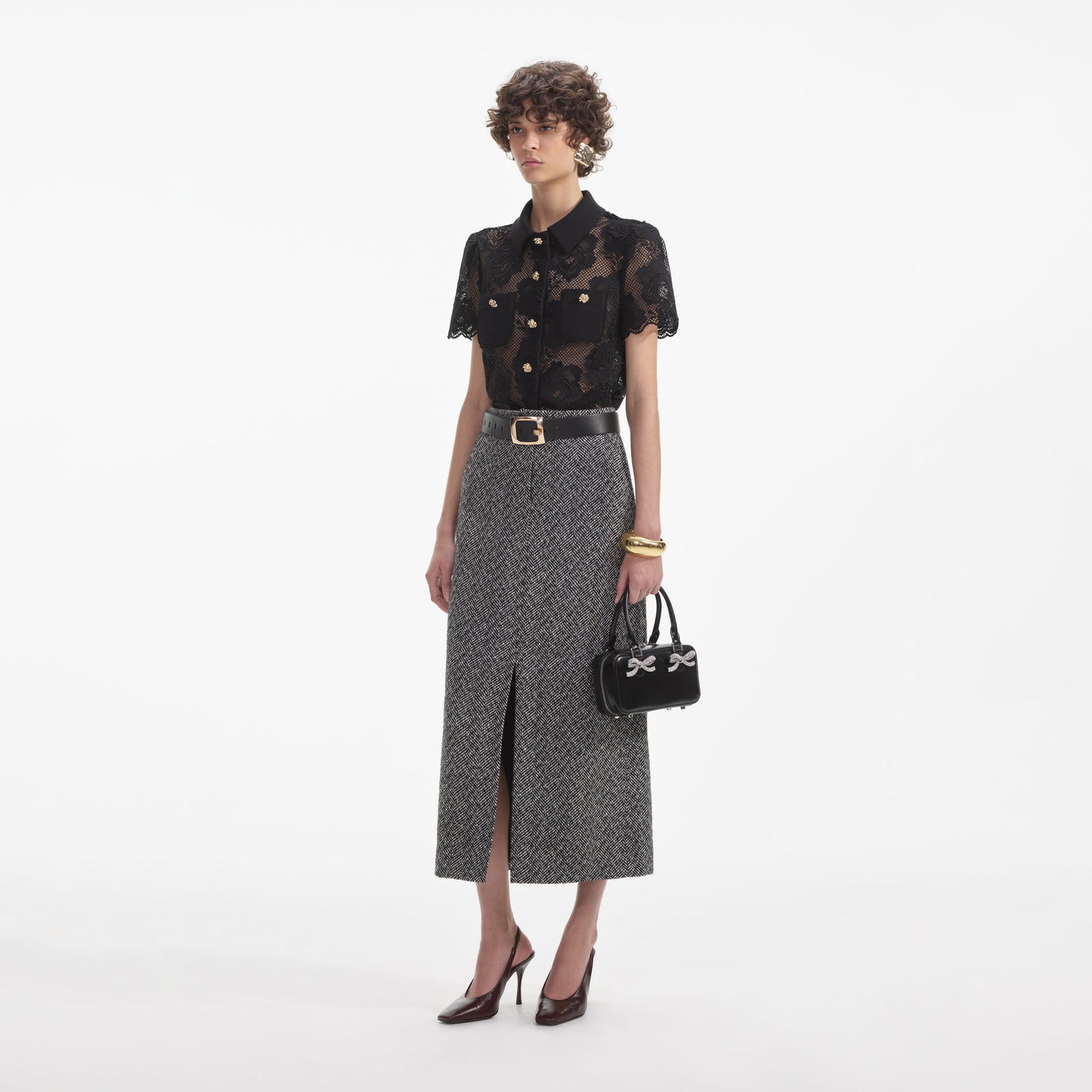 Side view of a woman wearing the Black Lace Top