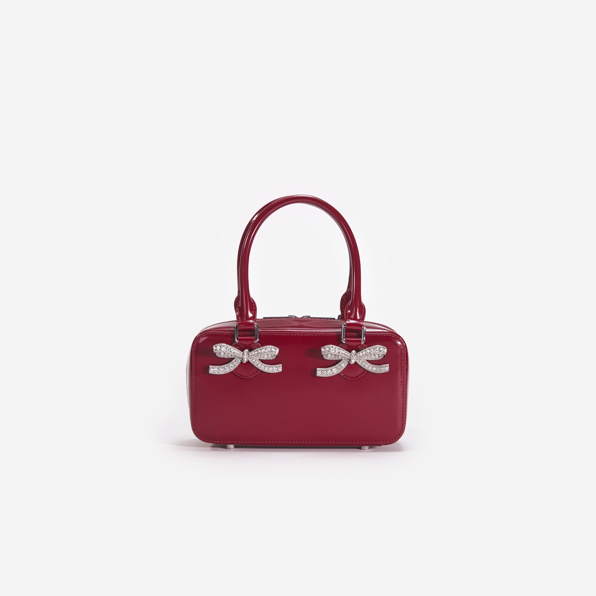 Front view of a woman wearing the Burgundy Leather Mini Tote Bag