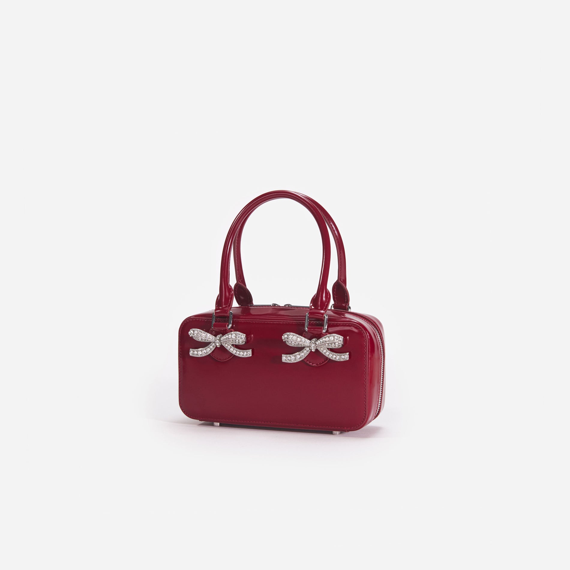 Side view of a woman wearing the Burgundy Leather Mini Tote Bag