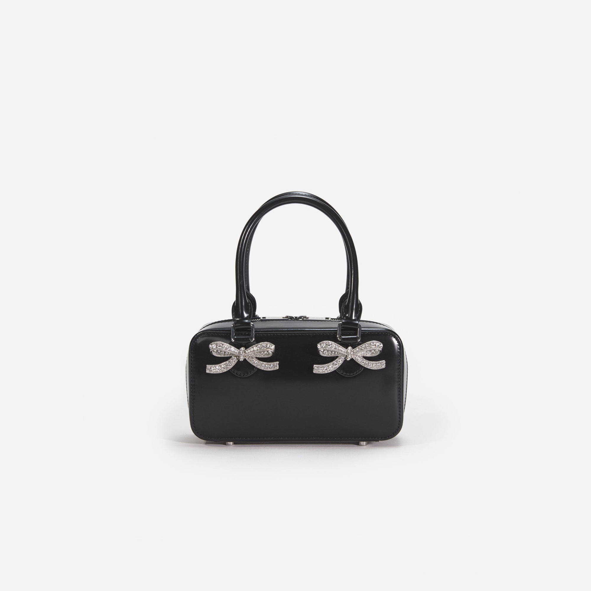 Front view of a woman wearing the Black Leather Mini Tote Bag