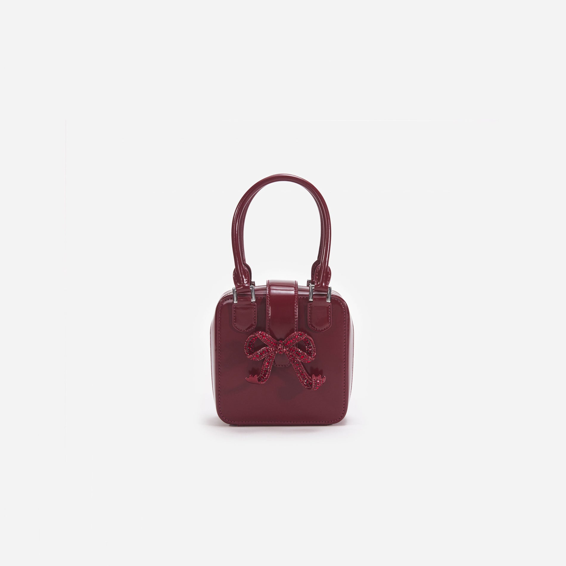 Front view of a woman wearing the Burgundy Leather Square Mini Tote Bag
