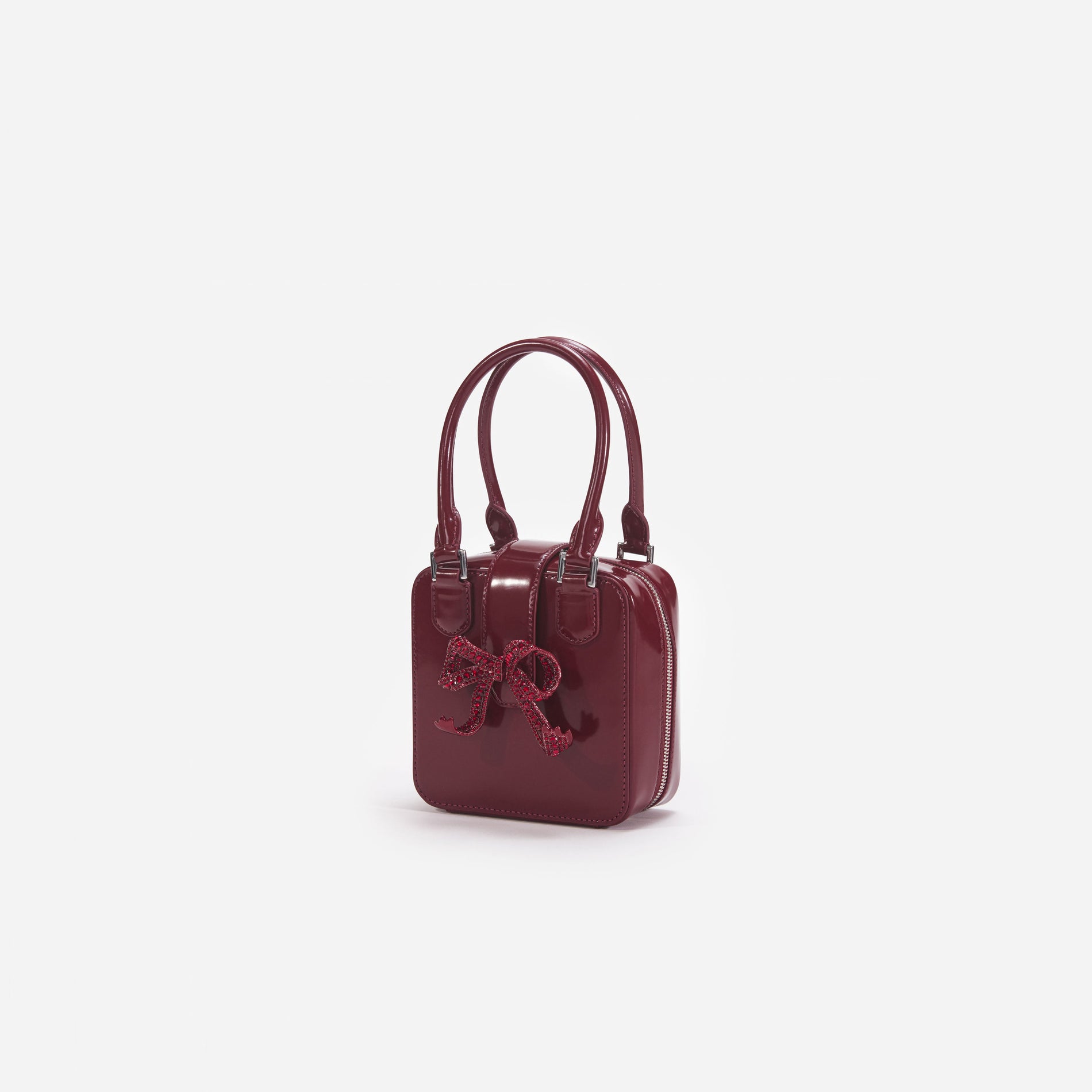 Side view of a woman wearing the Burgundy Leather Square Mini Tote Bag