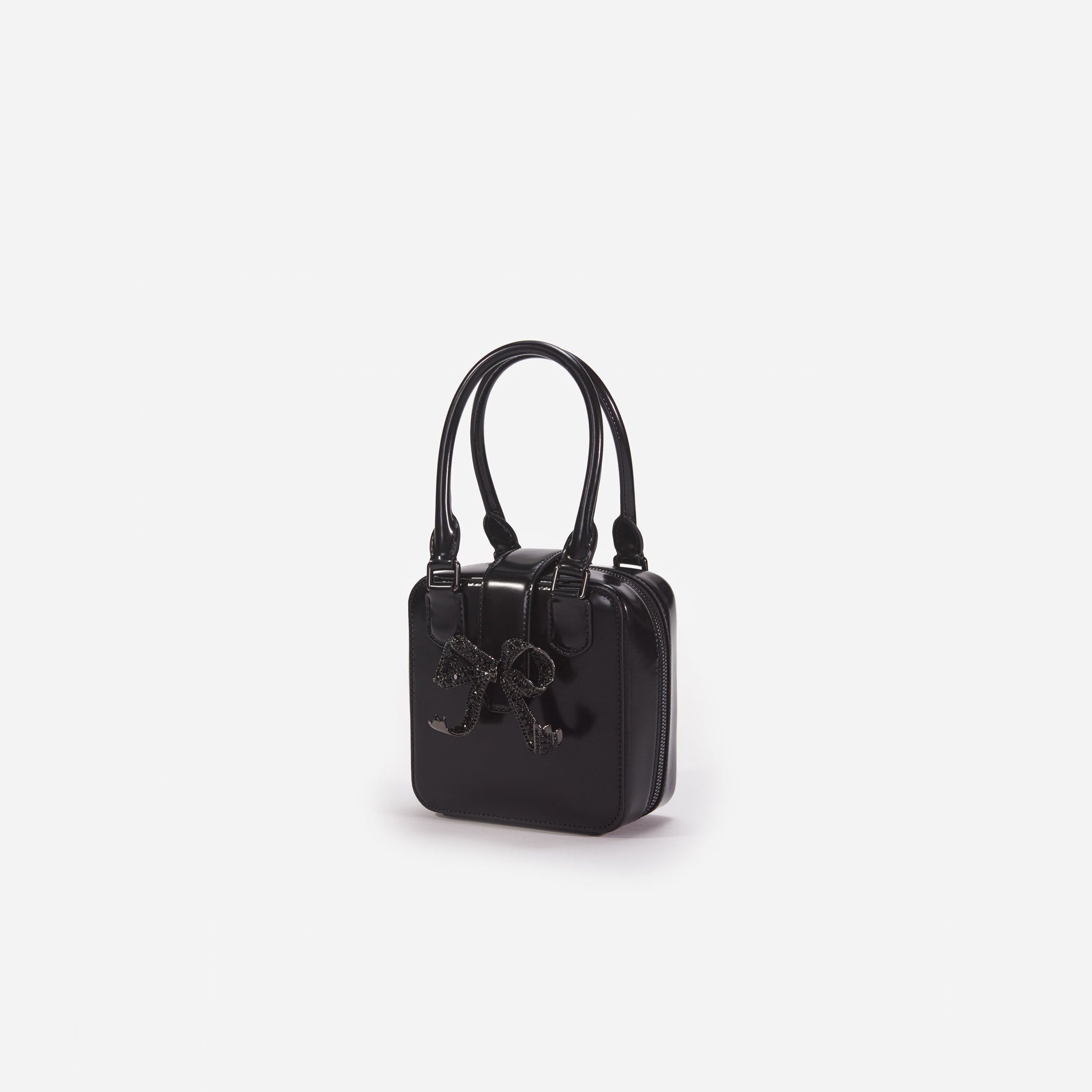 Side view of a woman wearing the Black Leather Square Mini Tote Bag