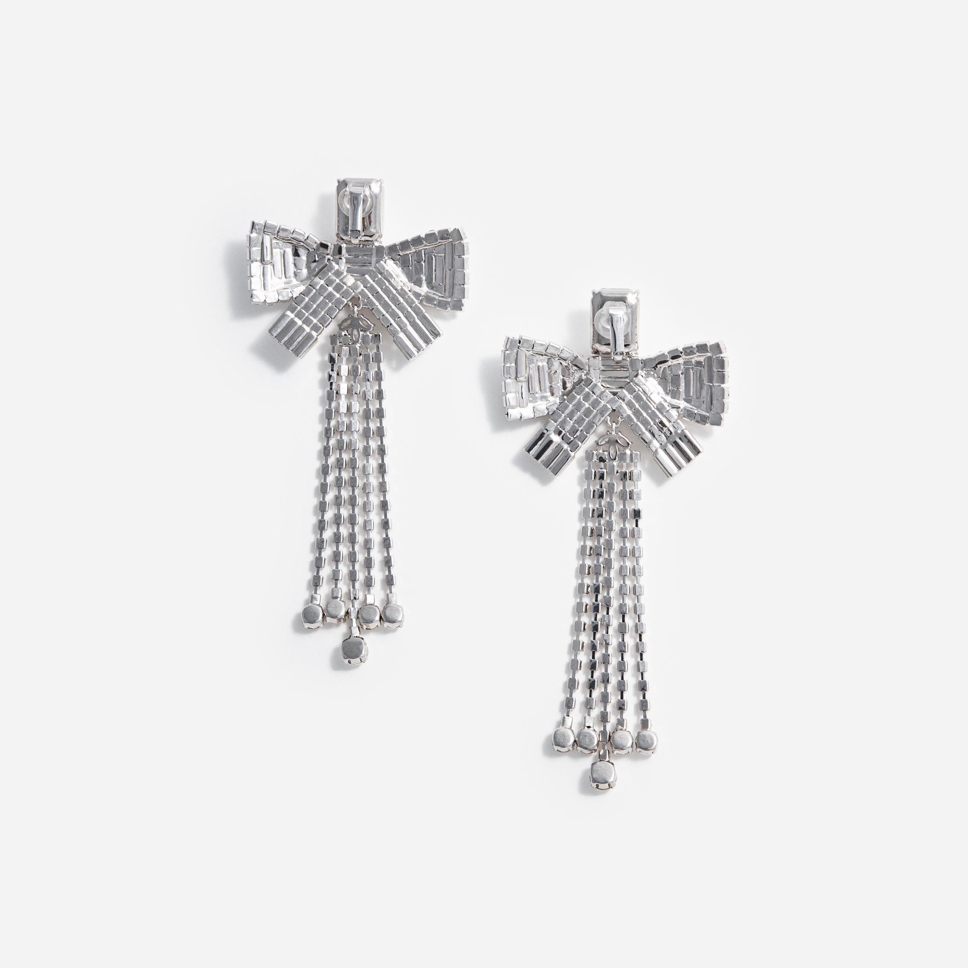 Side view of a woman wearing the Crystal Bow Droplet Earrings