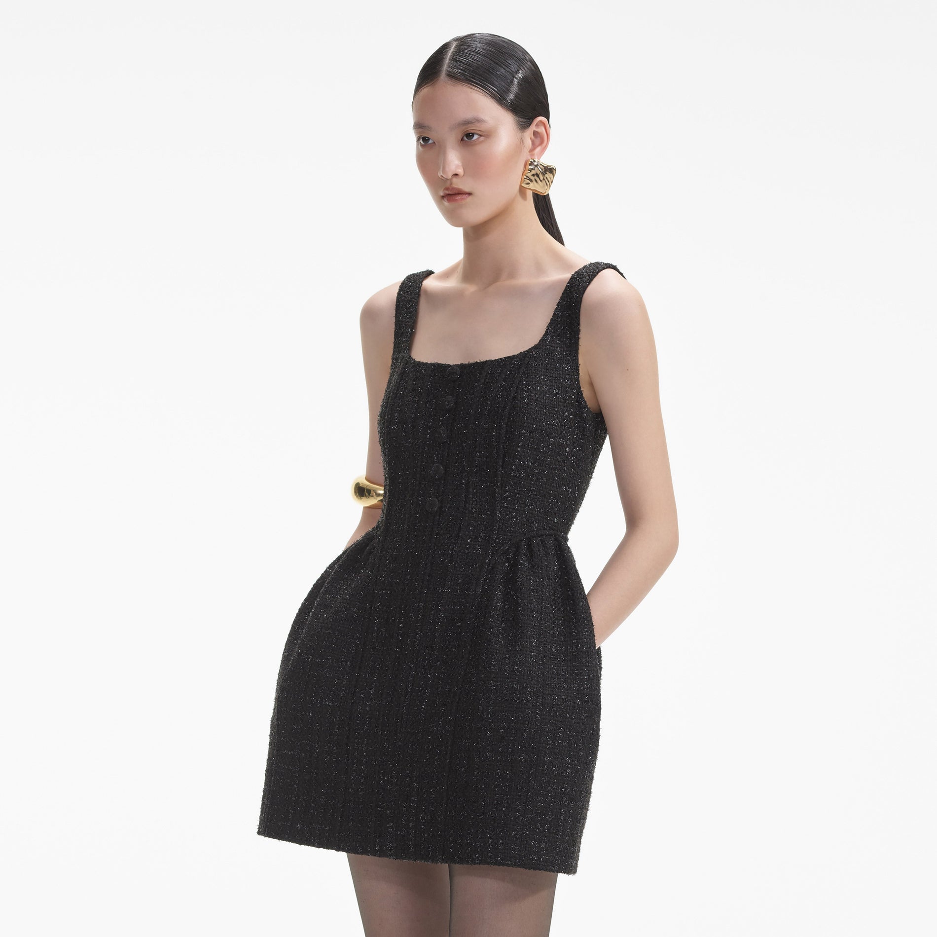 A close up of a woman wearing the Textured Gold Square Earrings