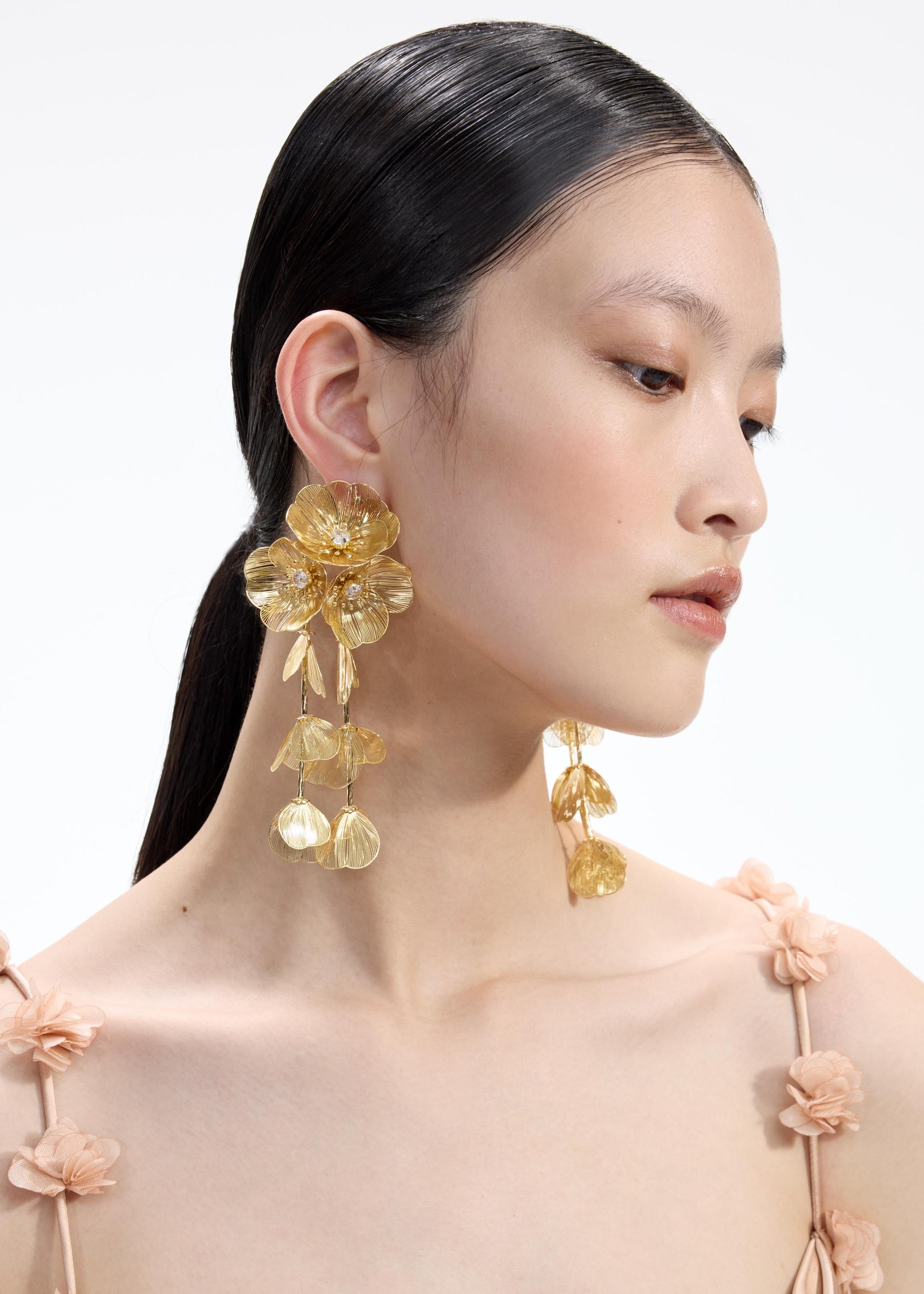 Back view of a woman wearing the White Gold Floral Earrings