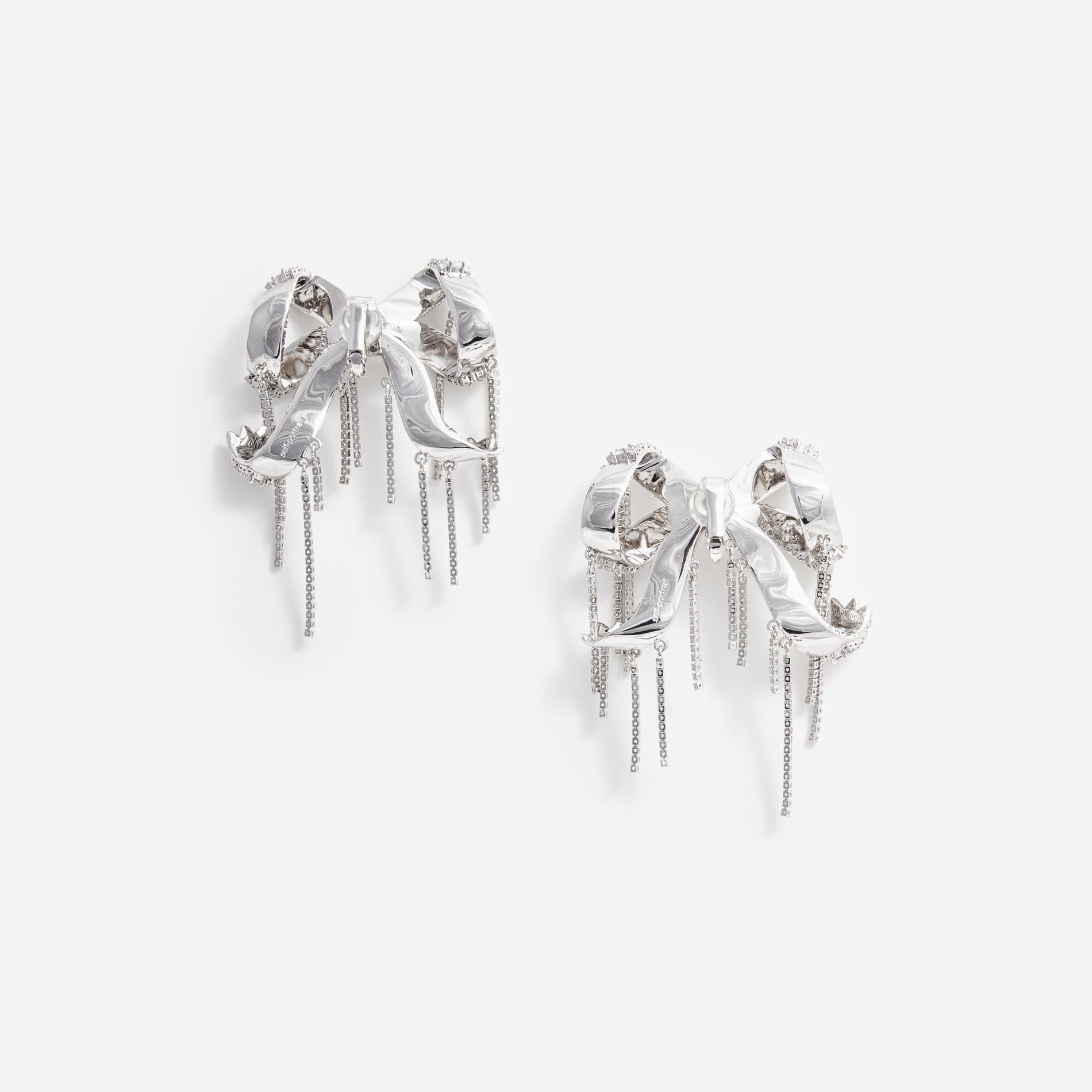 Side view of a woman wearing the Crystal Embellished Bow Earrings