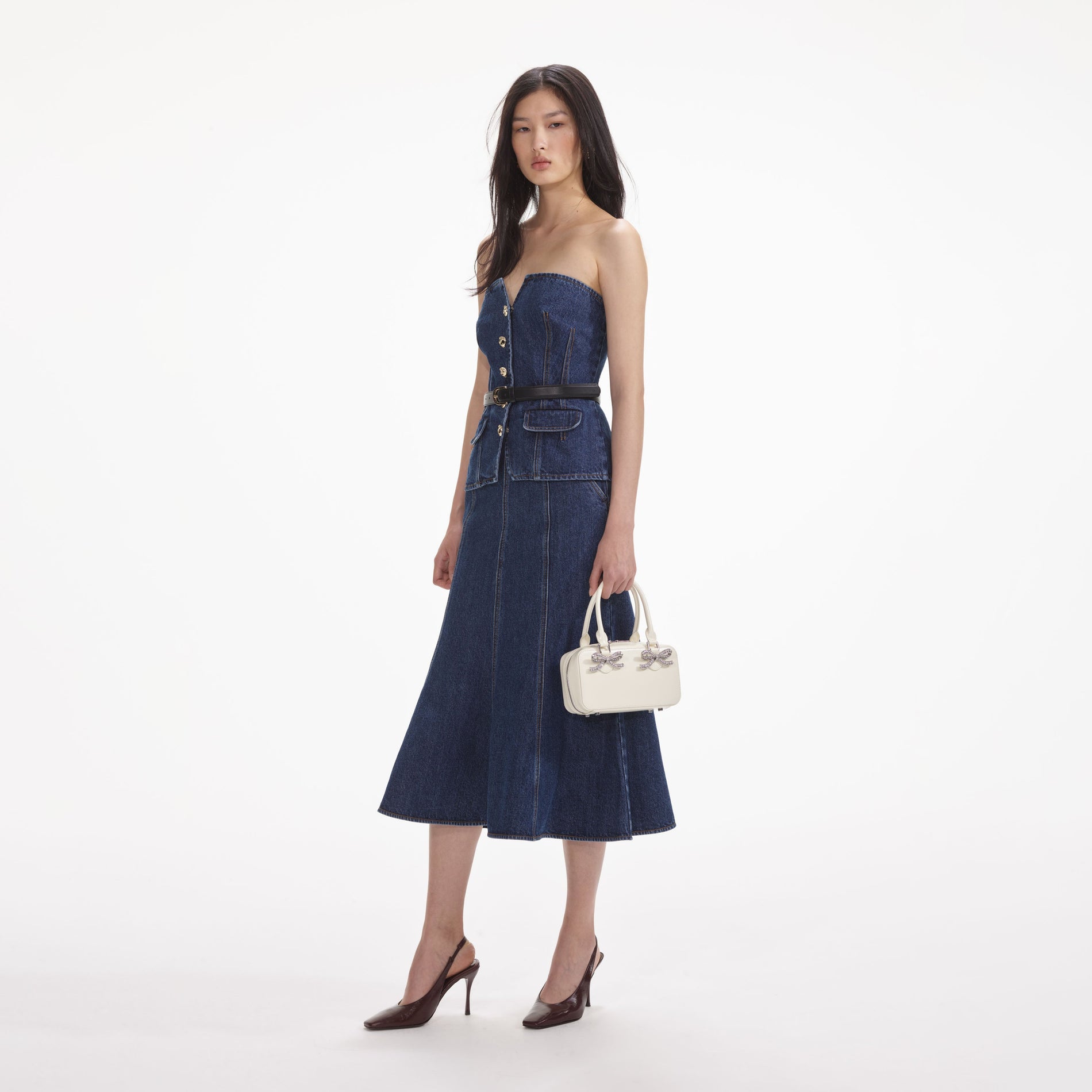 Side view of a woman wearing the Denim Bandeau Midi Dress