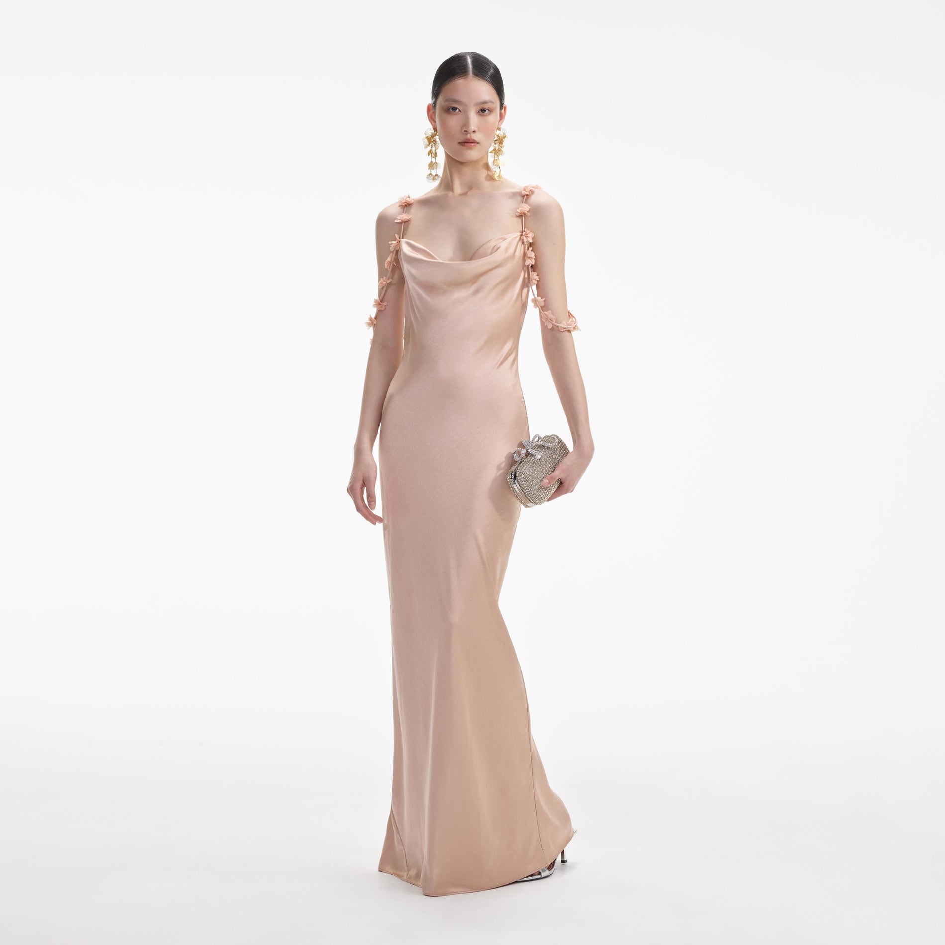 Front view of a woman wearing the Rose Gold Satin Flower Maxi Dress