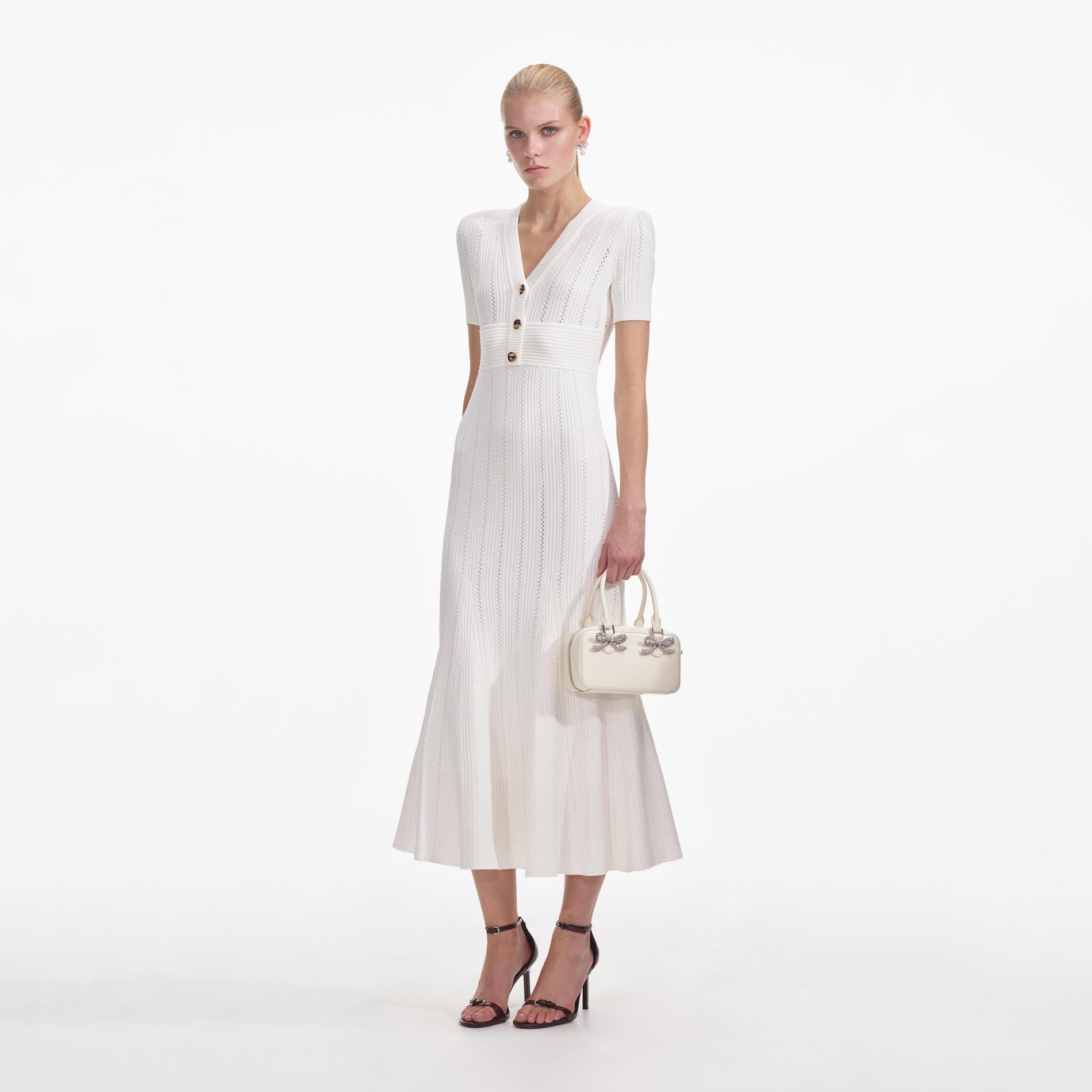 Side view of a woman wearing the Cream Pointelle Knit Midi Dress