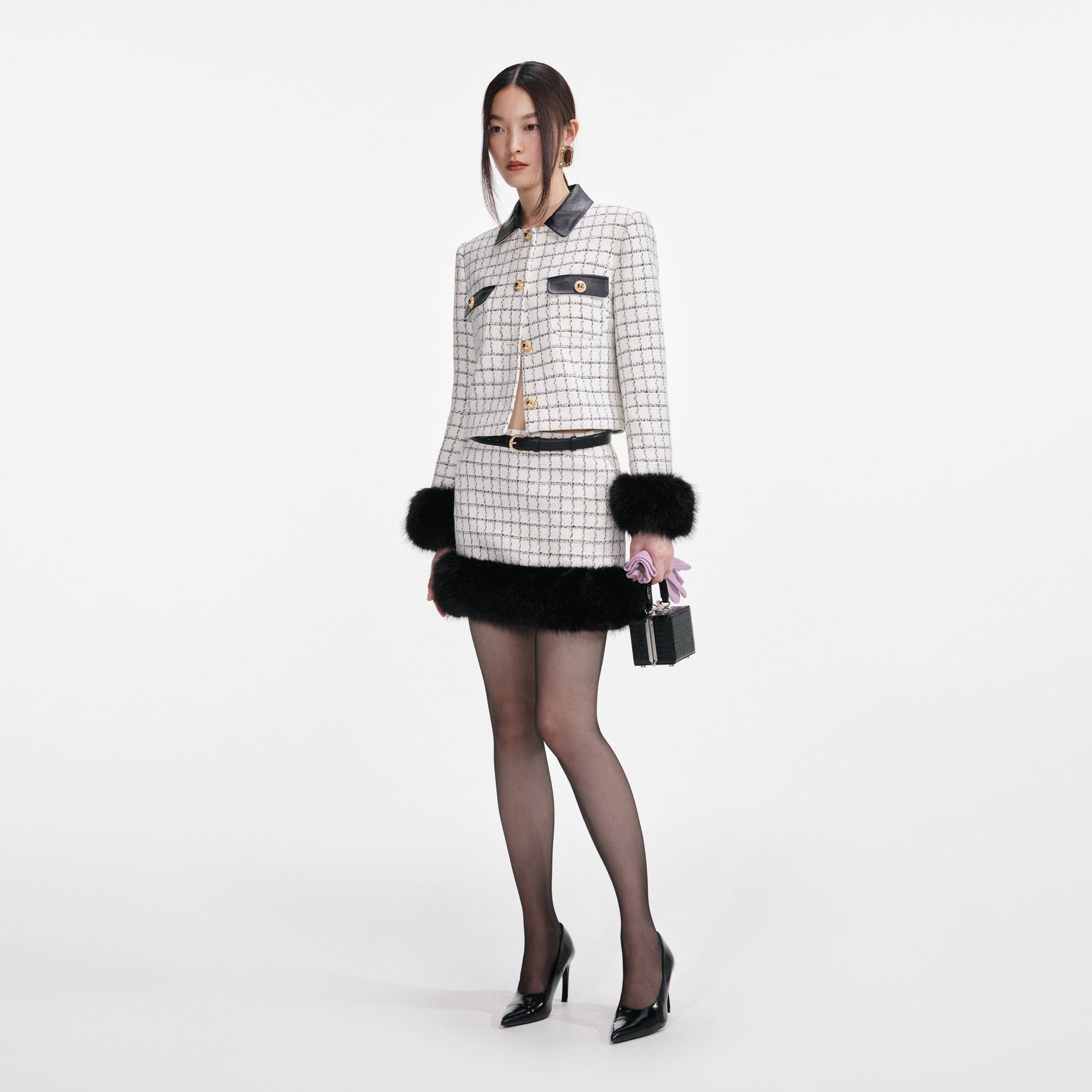 Side view of a woman wearing the Check Boucle Fur Hem Mini Skirt