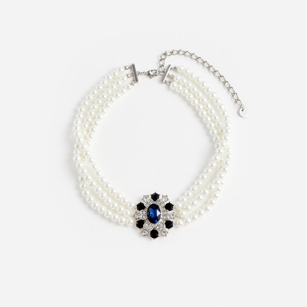 Three strand pearl necklace with a blue and clear gemstone floral pendant