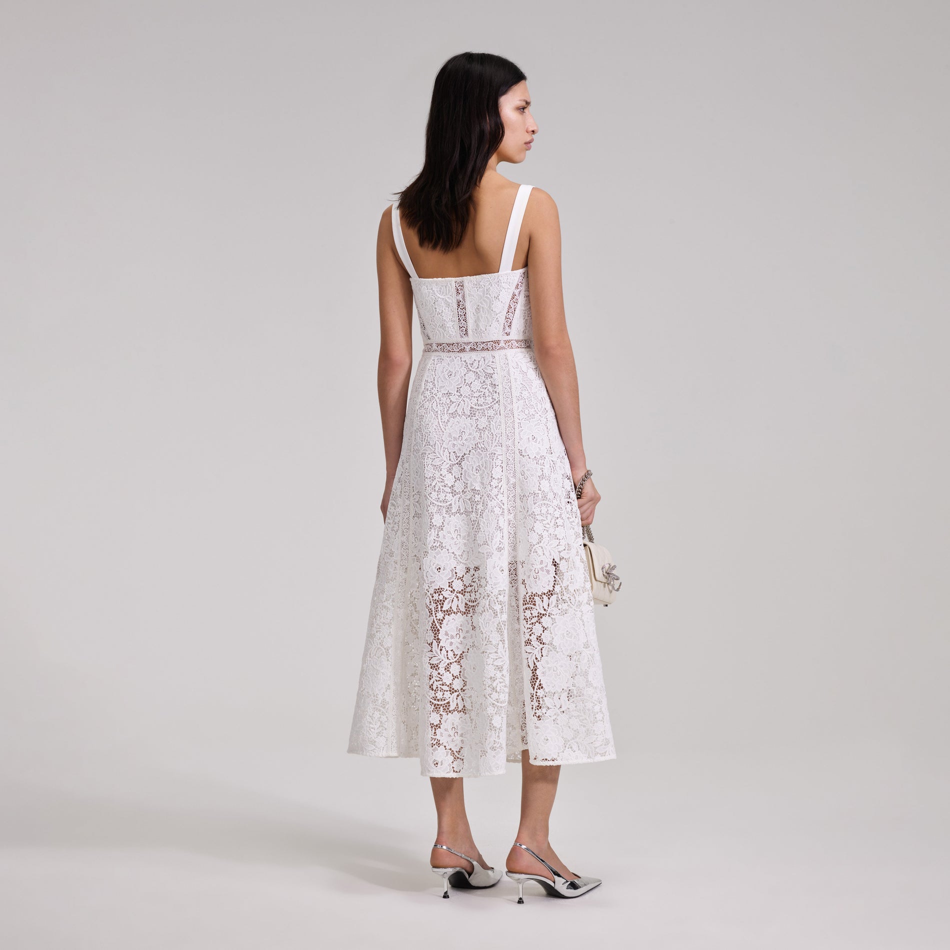 A woman wearing the White Cord Lace Midi Dress