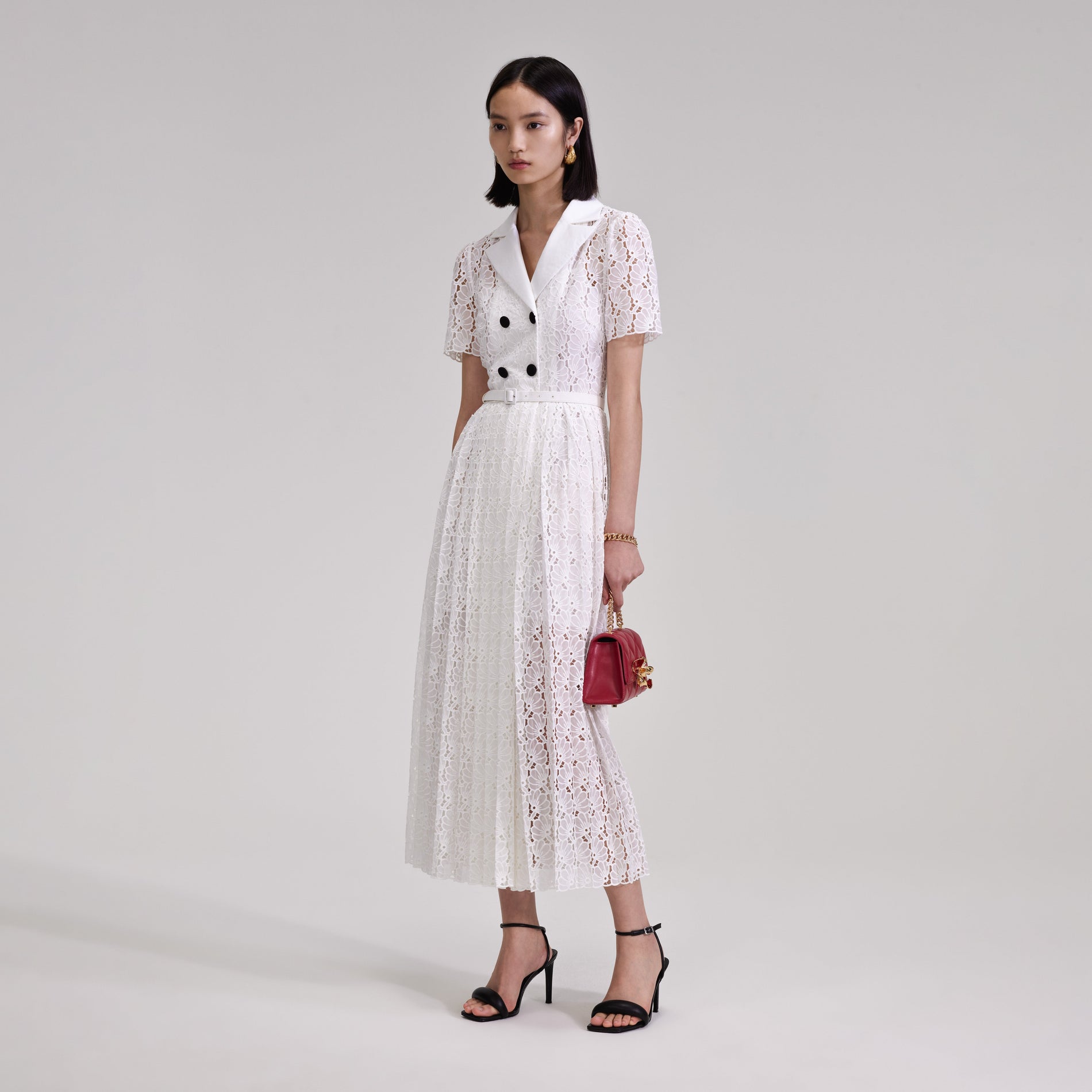 A woman wearing the White Floral Chiffon Midi Dress