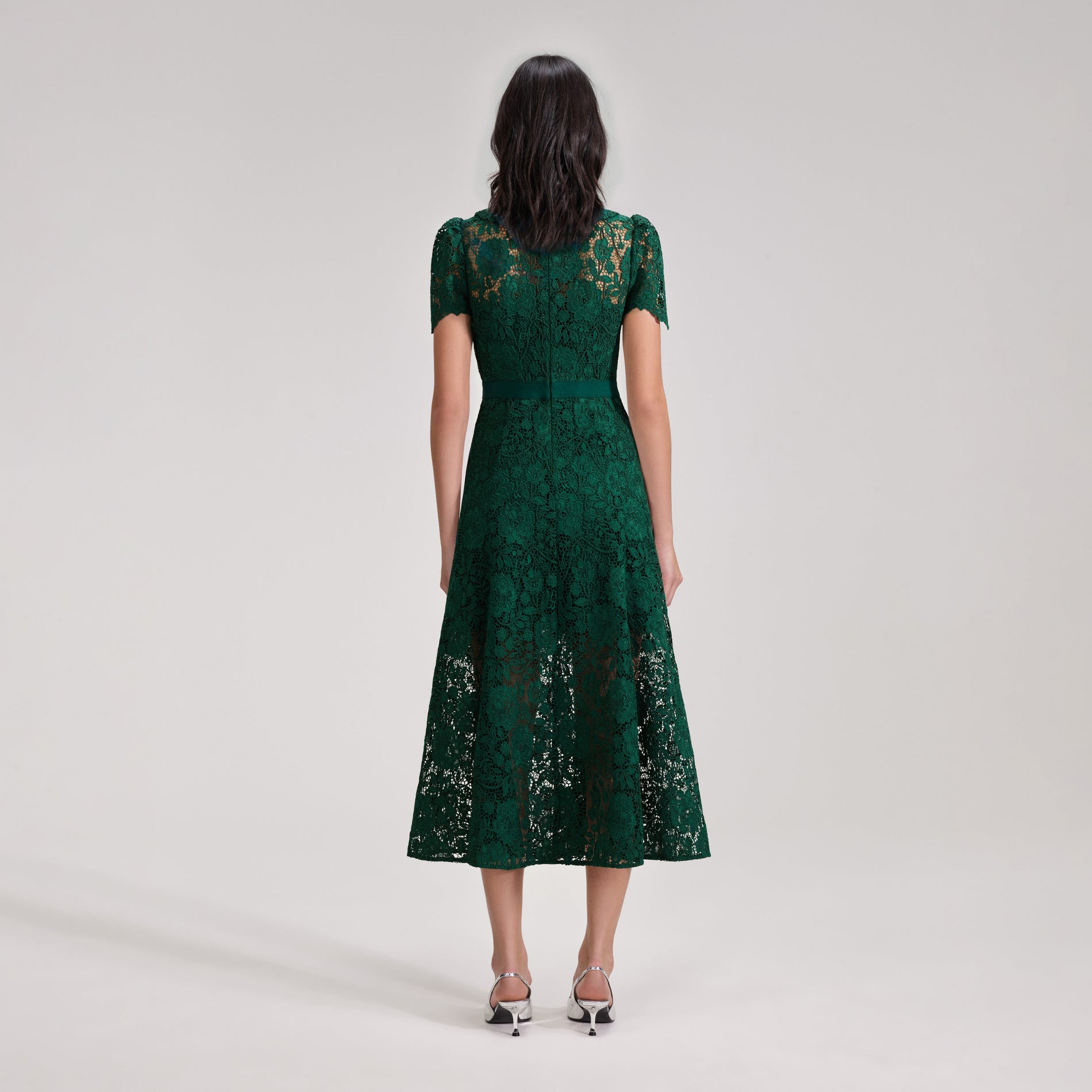 A woman wearing the Green Cord Lace Midi Dress