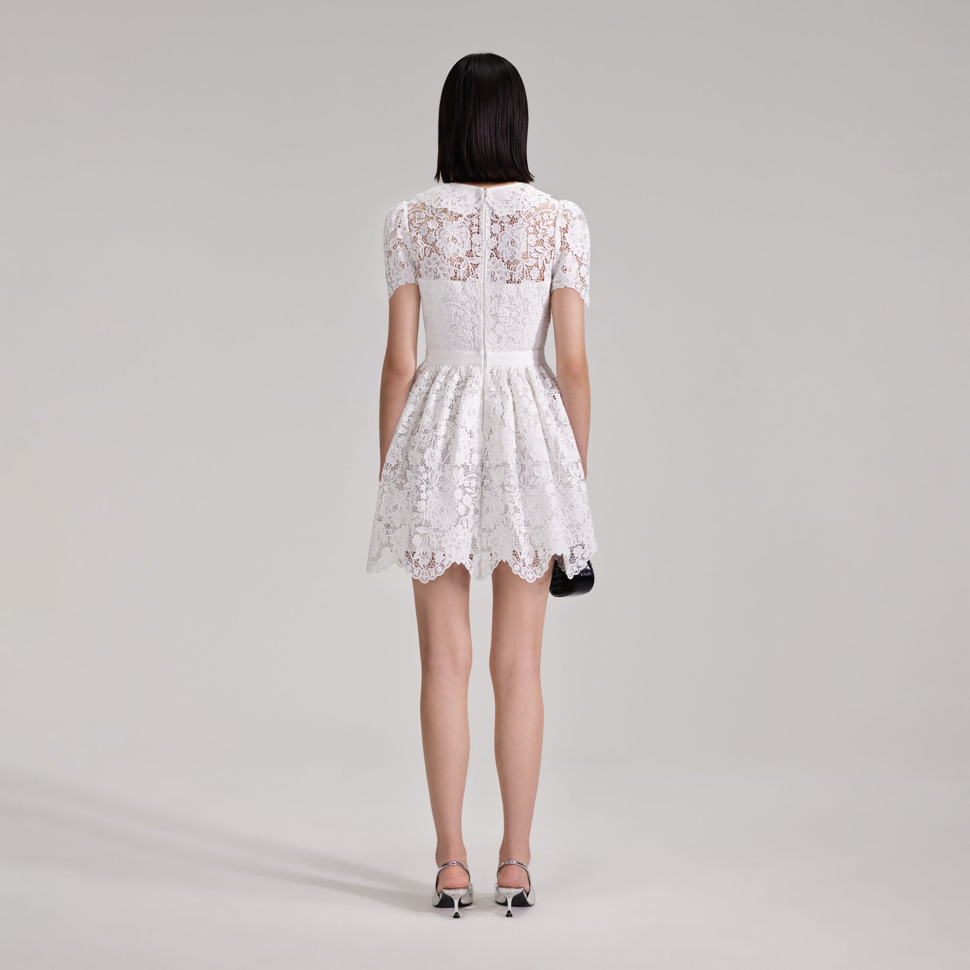 A woman wearing the White Cord Lace Collar Mini Dress