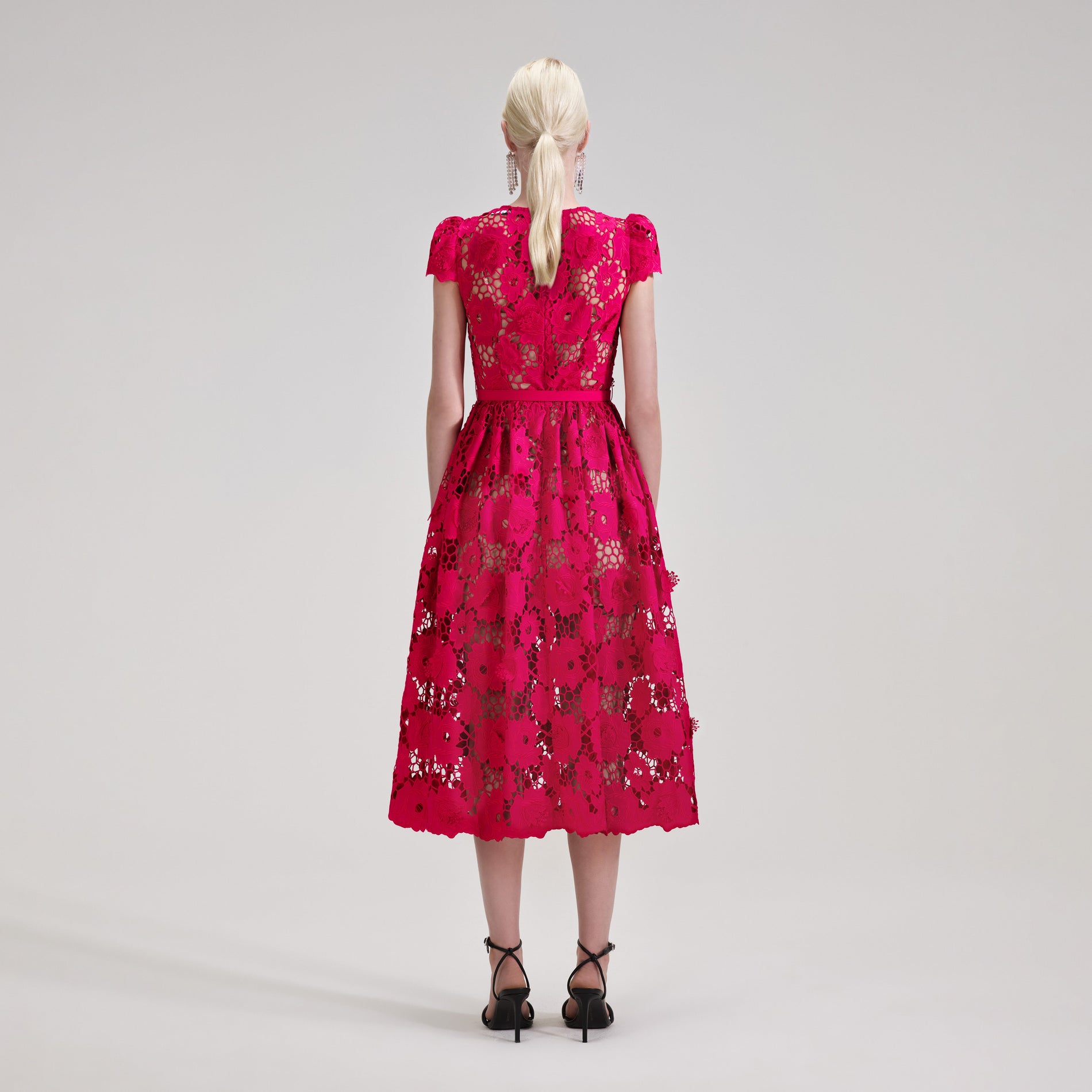 A woman wearing the Poppy Midi Dress