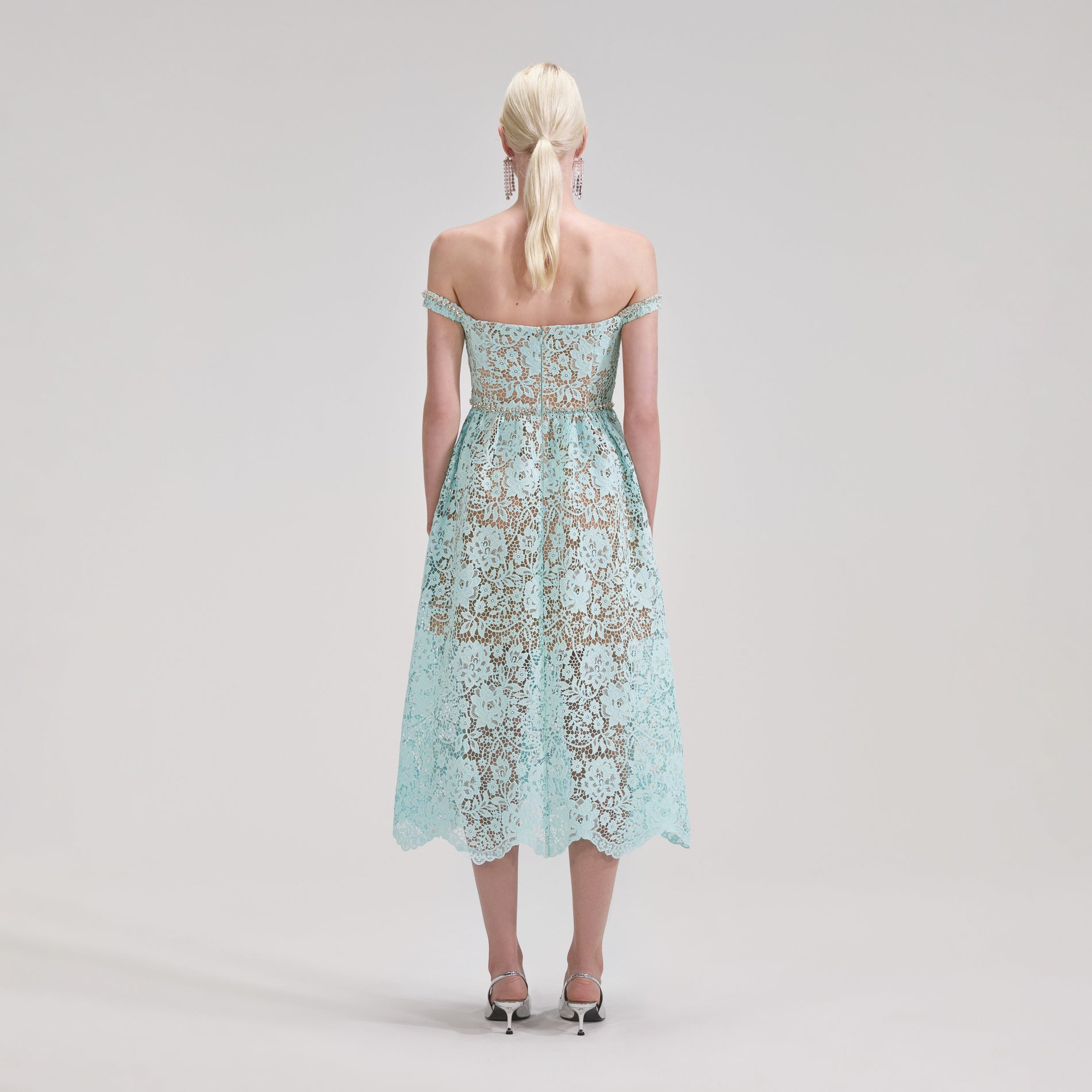 A woman wearing the Blue Cord Lace Diamante Midi Dress