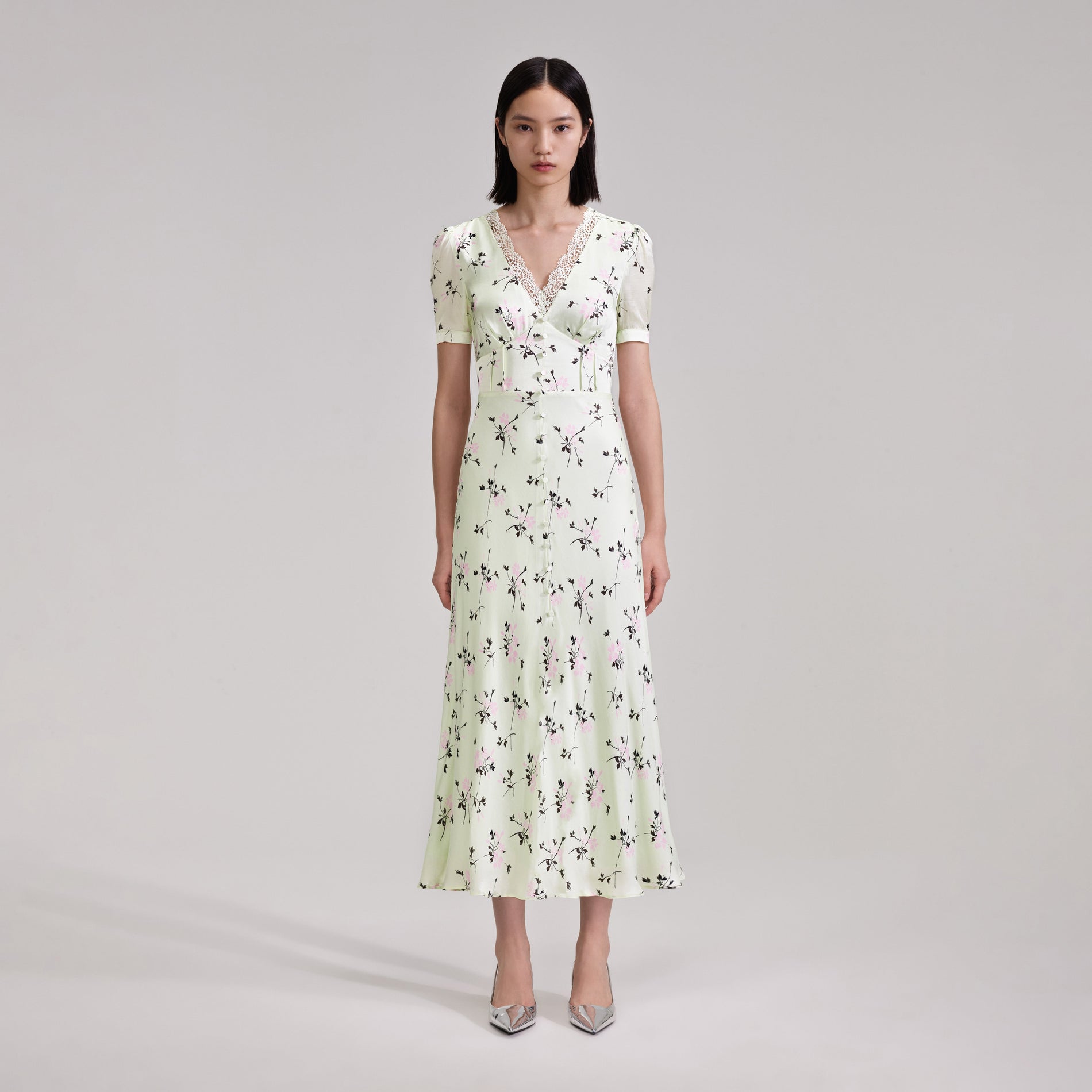 A woman wearing the Green Floral Print Lace Detail Midi Dress