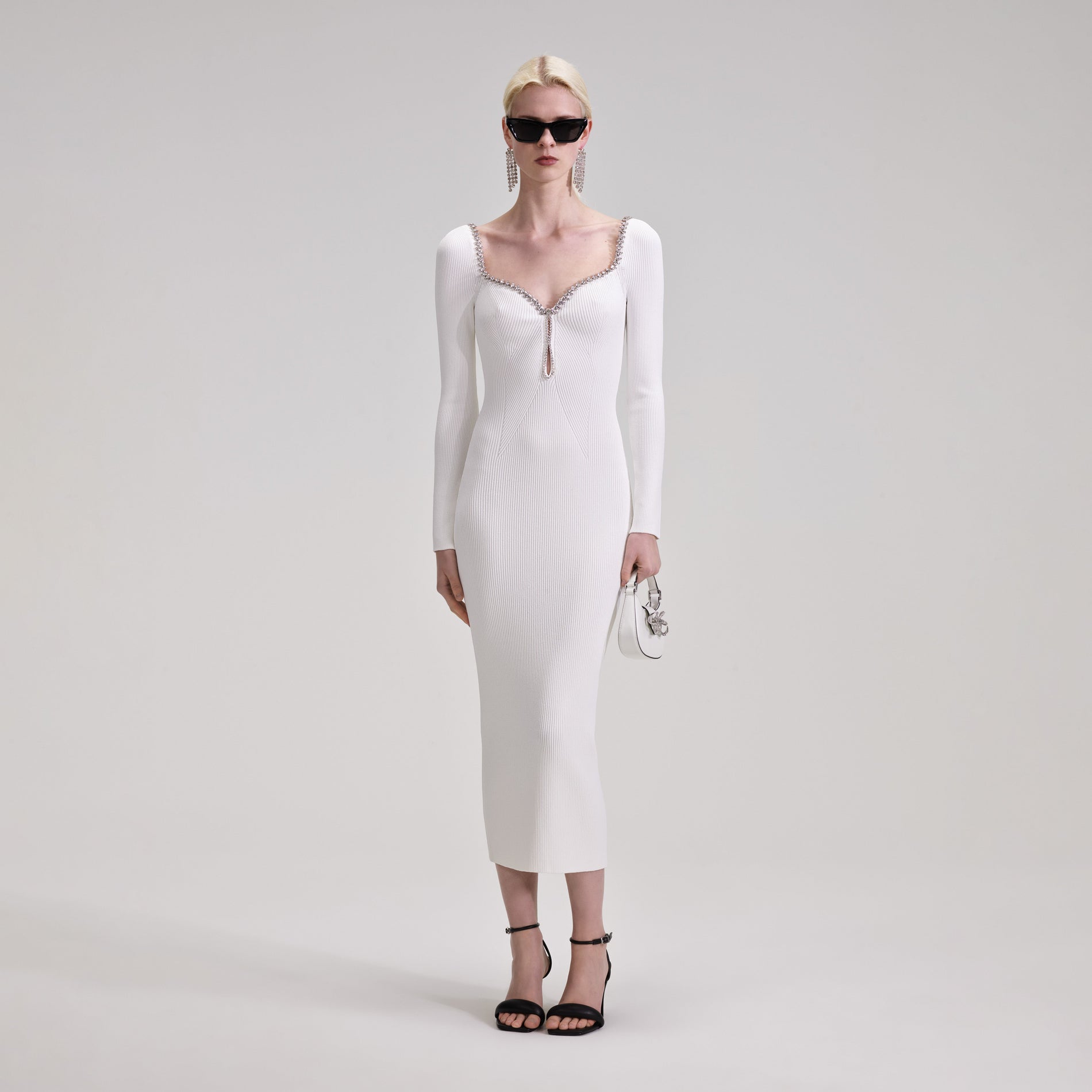 A woman wearing the White Knit Diamante Midi Dress