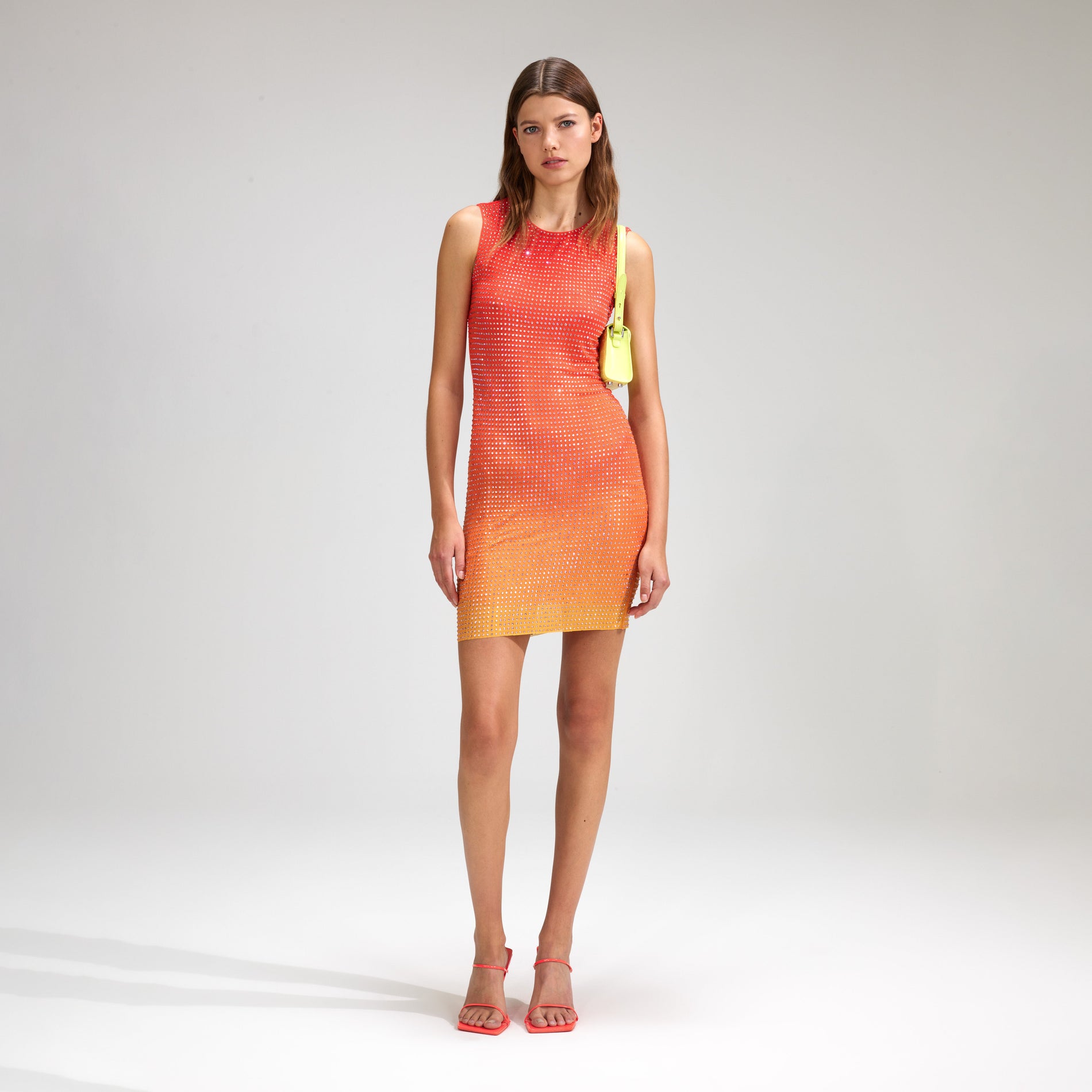 A woman wearing the Pink Rhinestone Mesh Mini Dress