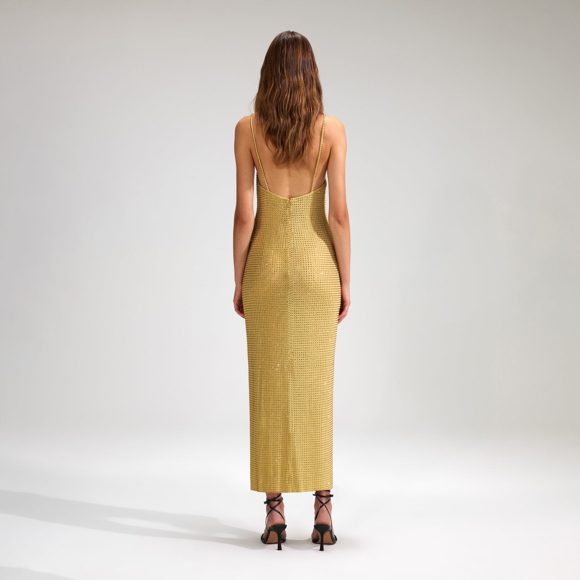 A woman wearing the Yellow Rhinestone Mesh Midi Dress