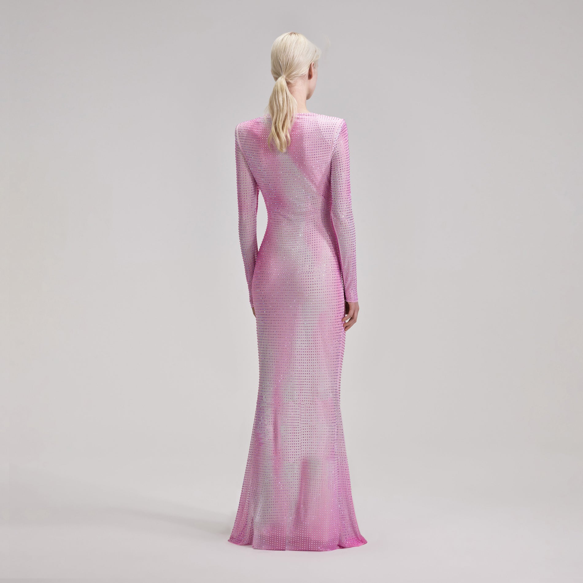 A woman wearing the Pink Contour Flared Hem Maxi Dress