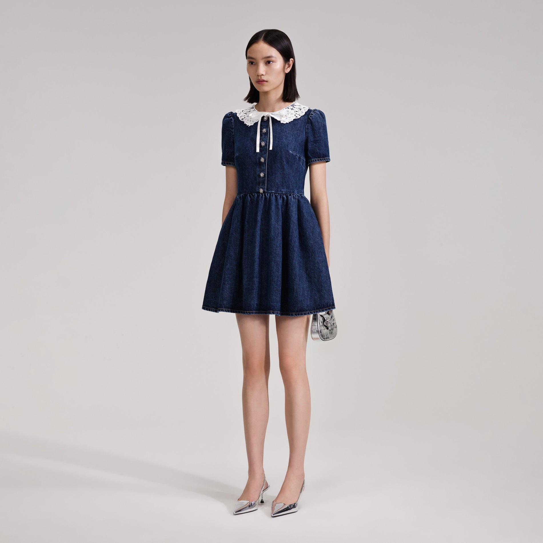 A woman wearing the Lace Collar Denim Mini Dress