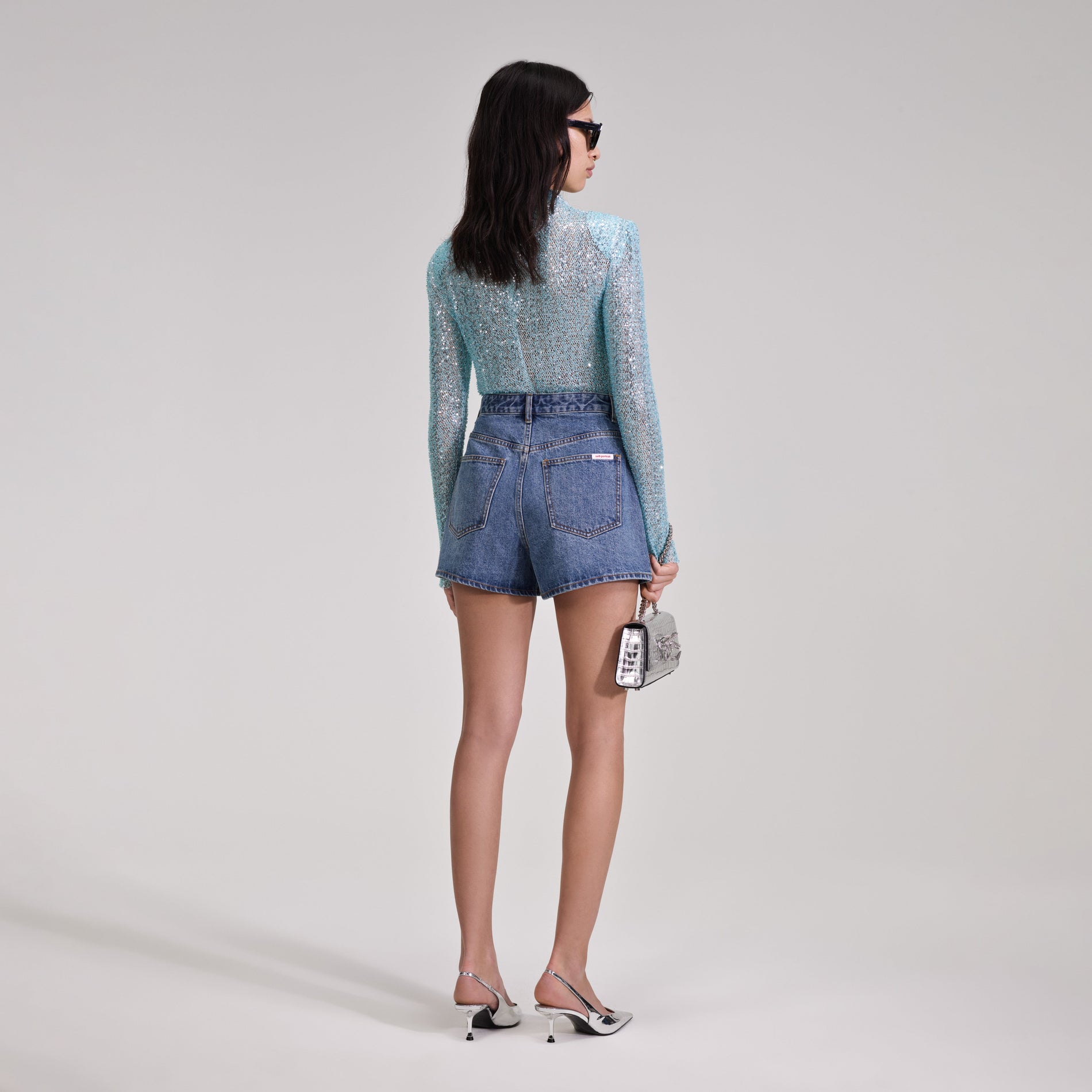 A woman wearing the Denim Shorts