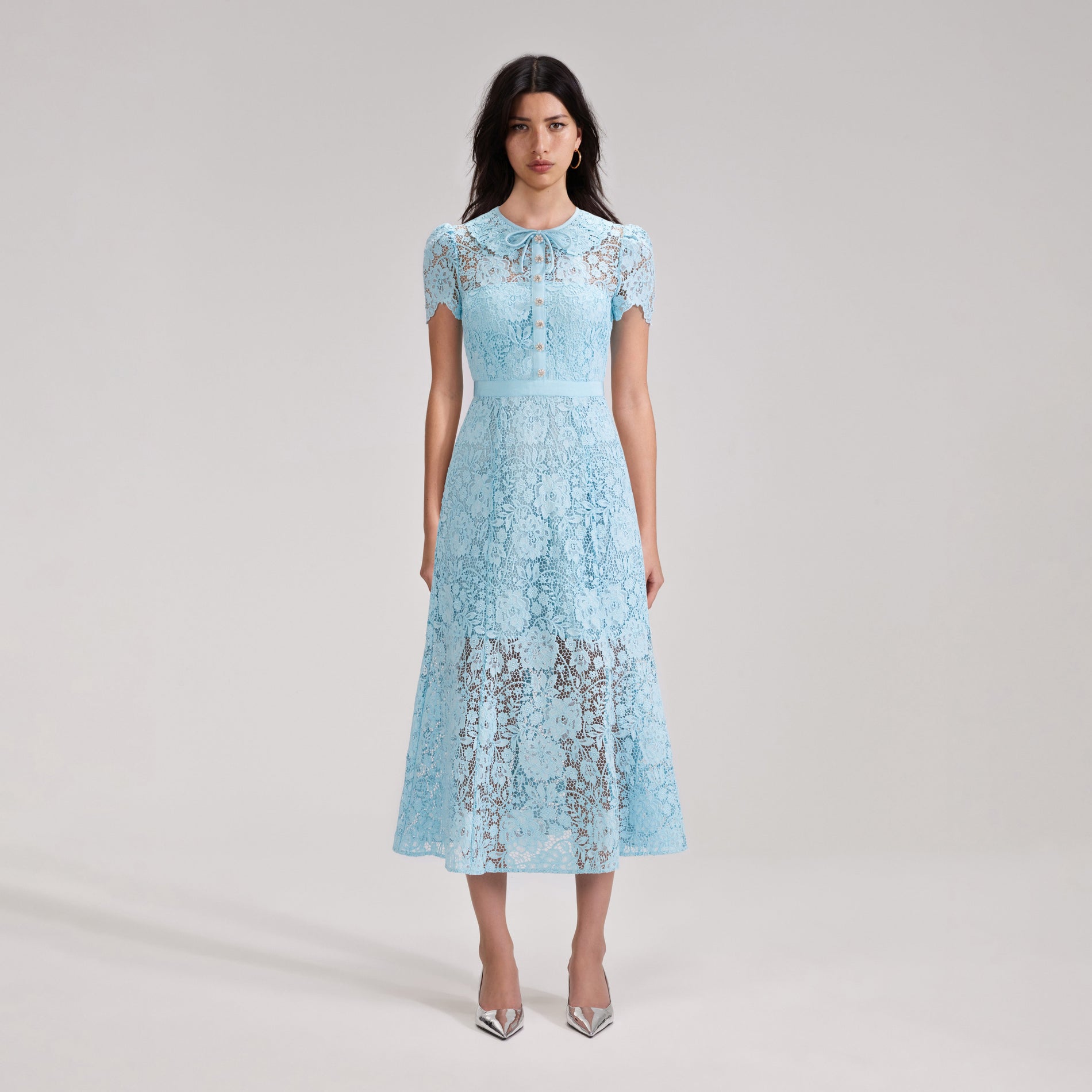 A woman wearing the Pale Blue Cord Lace Midi Dress