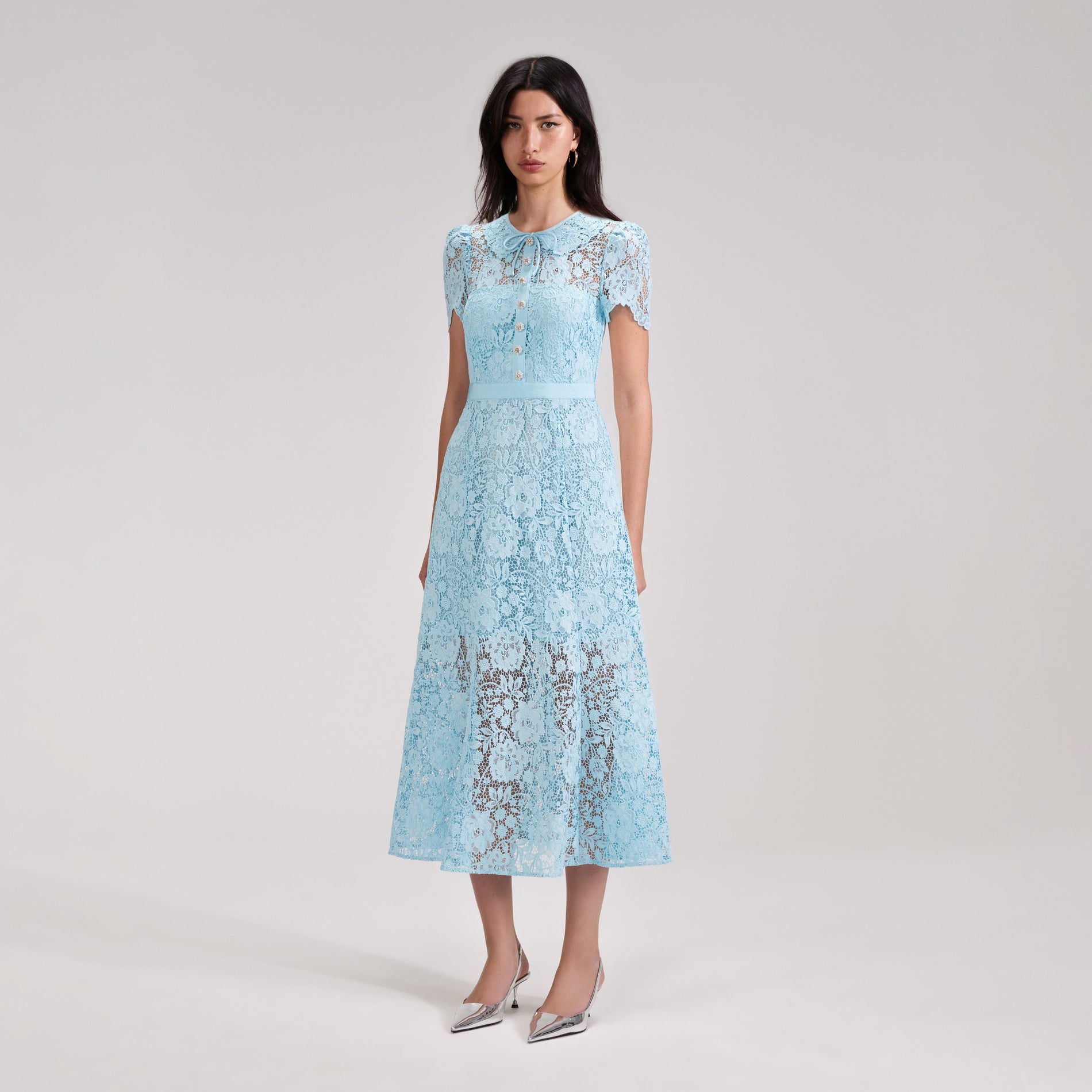 A woman wearing the Pale Blue Cord Lace Midi Dress