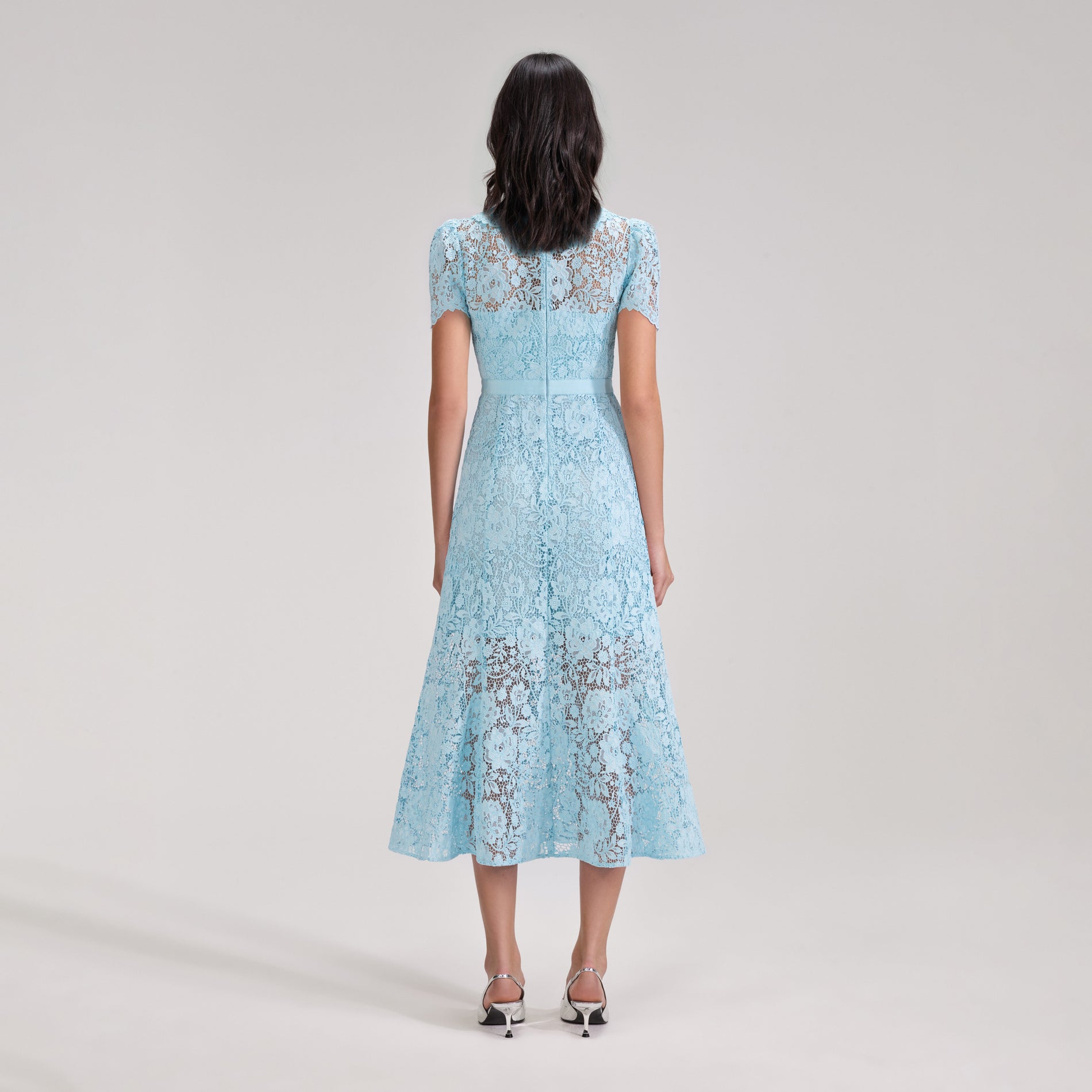 A woman wearing the Pale Blue Cord Lace Midi Dress