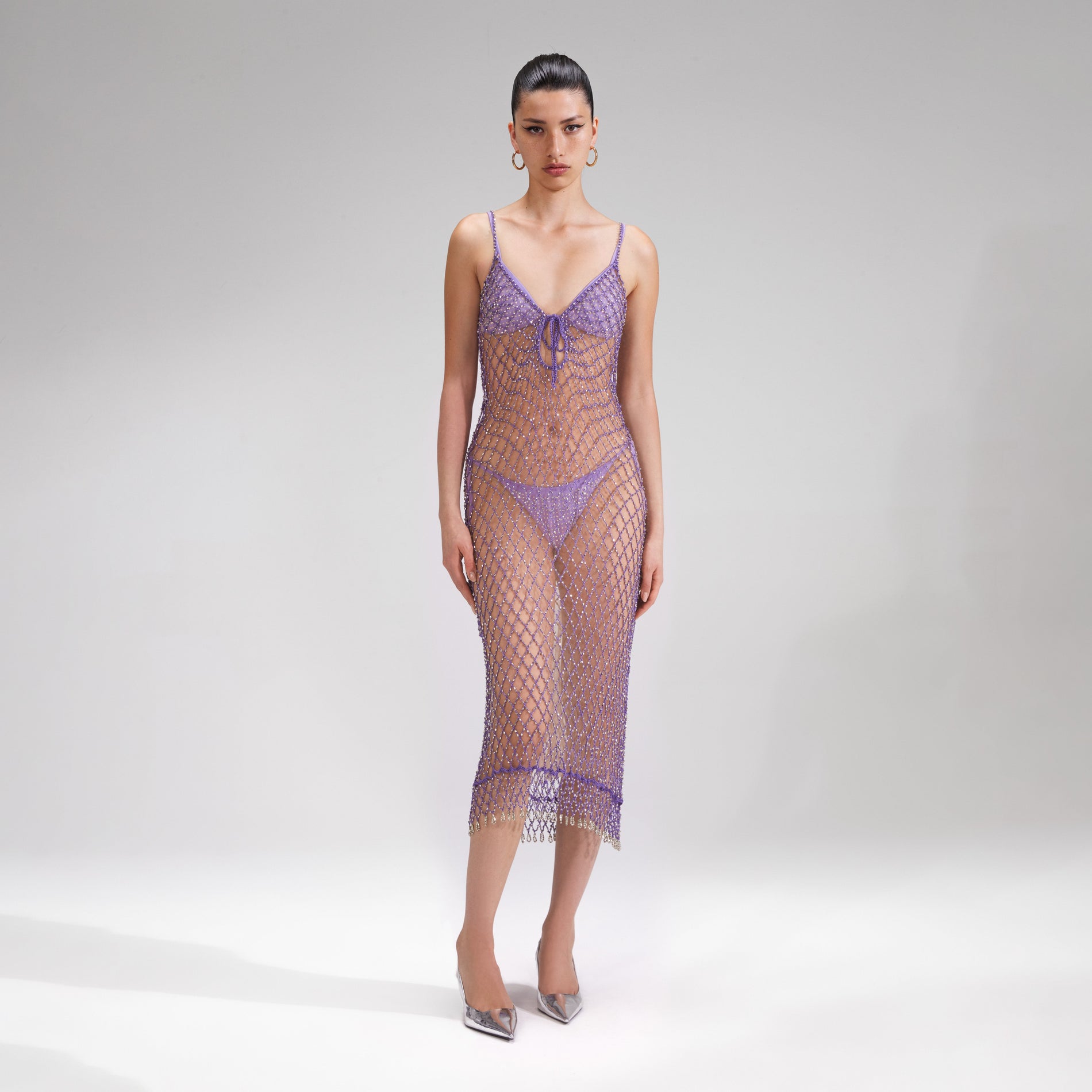 A woman wearing the Purple Beaded Fishnet Midi Dress