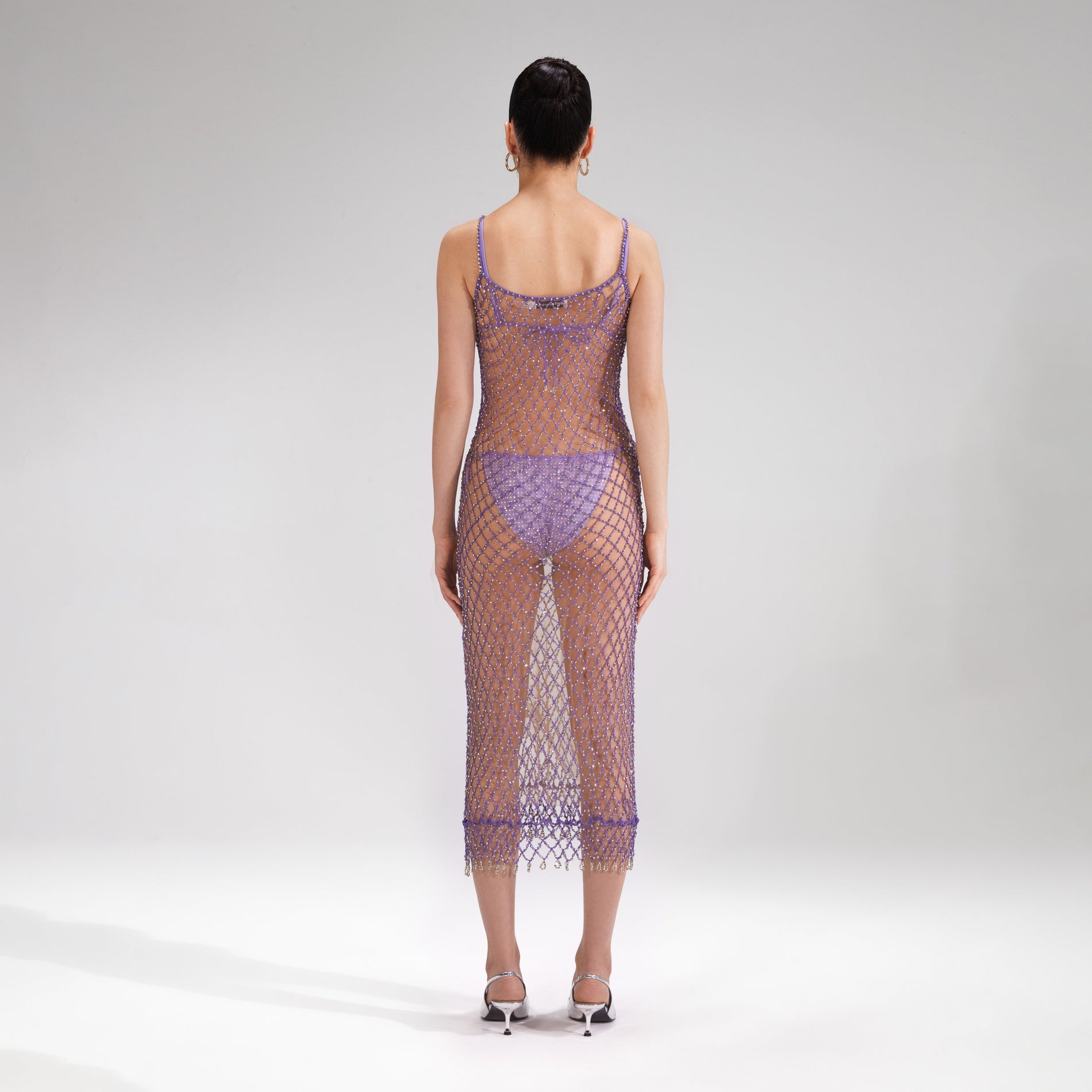 A woman wearing the Purple Beaded Fishnet Midi Dress