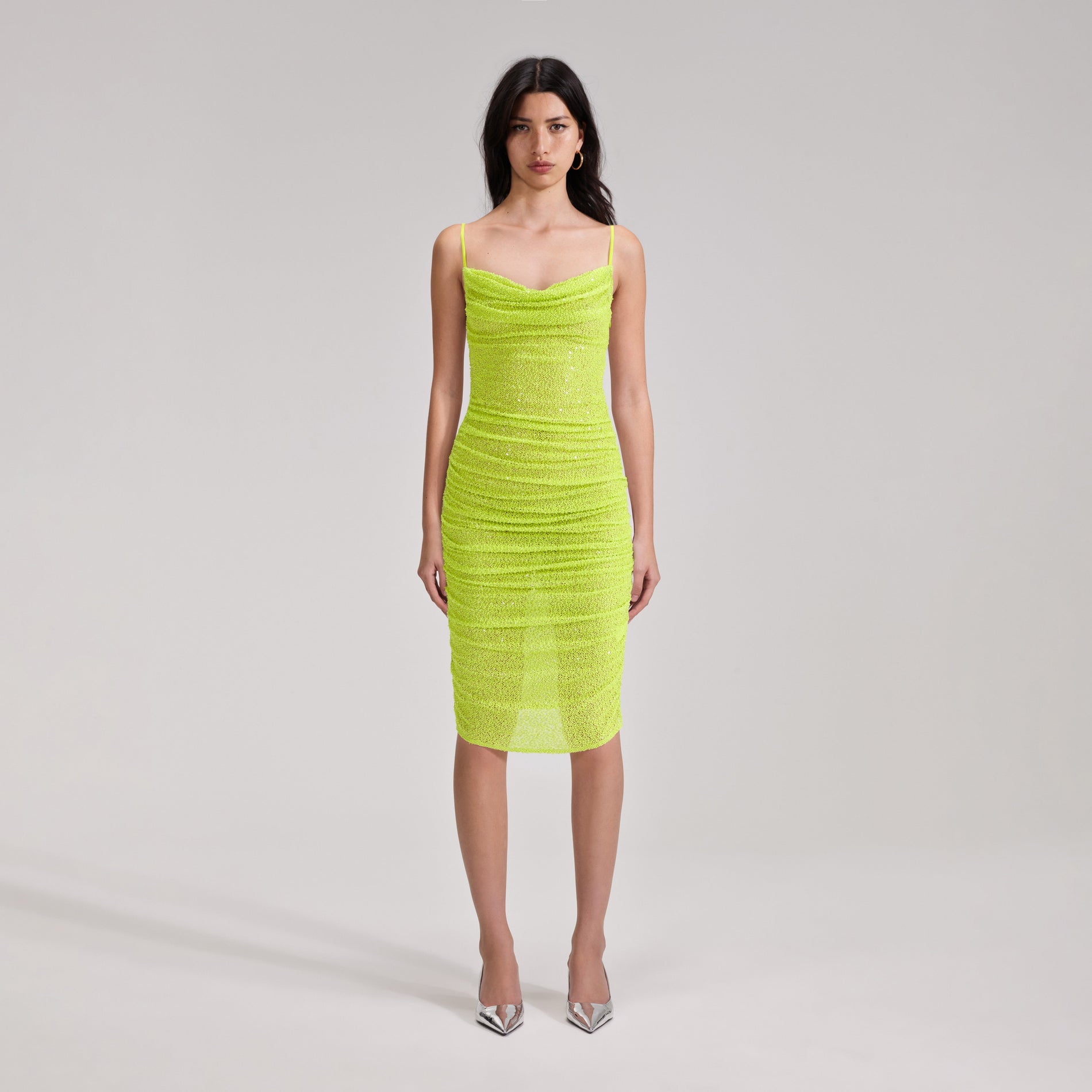 A woman wearing the Green Beaded Midi Dress