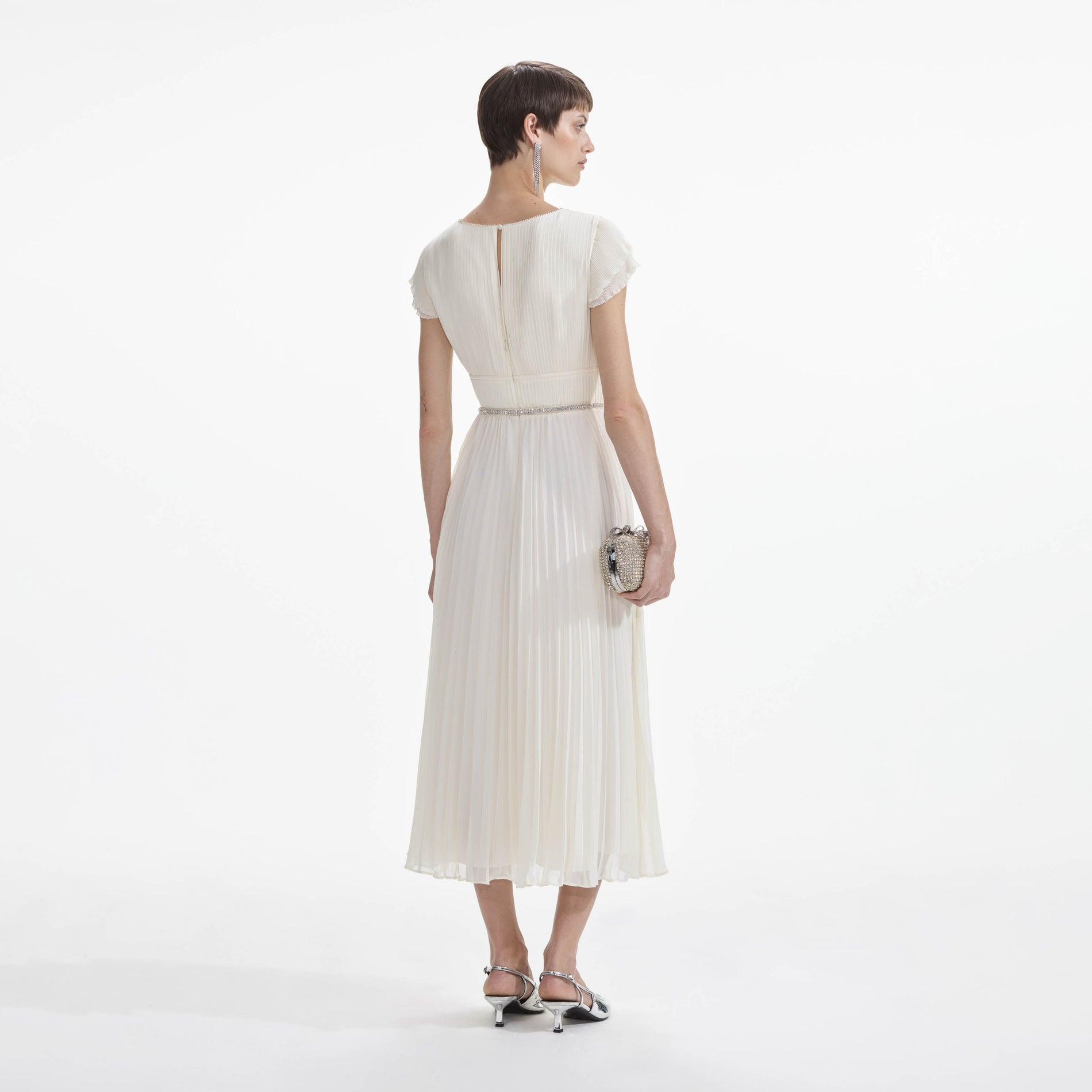 Back view of a woman wearing the Cream Chiffon Pleated Midi Dress