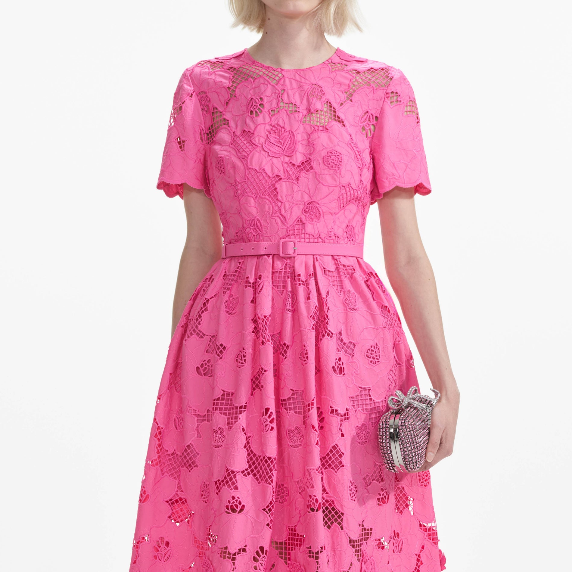 A close up of a woman wearing the Pink Cotton Lace  Midi Dress