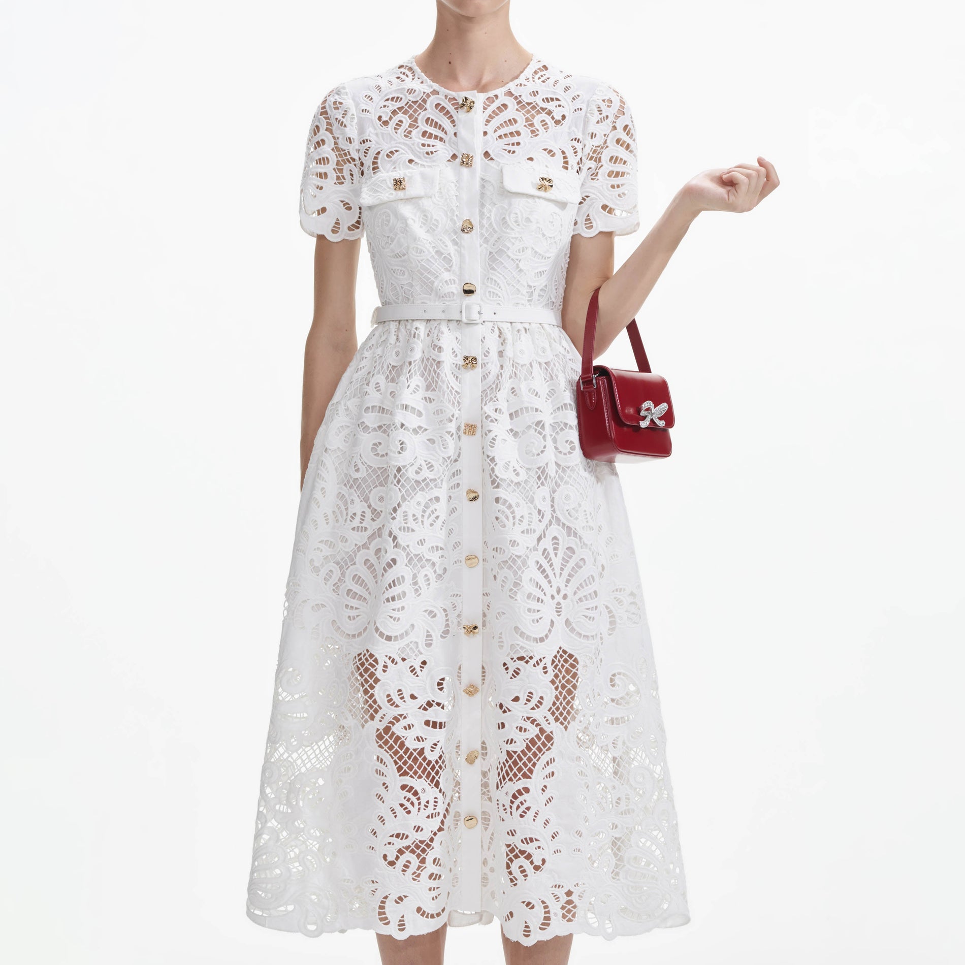 A close up of a woman wearing the White Cotton Lace Button Midi Dress
