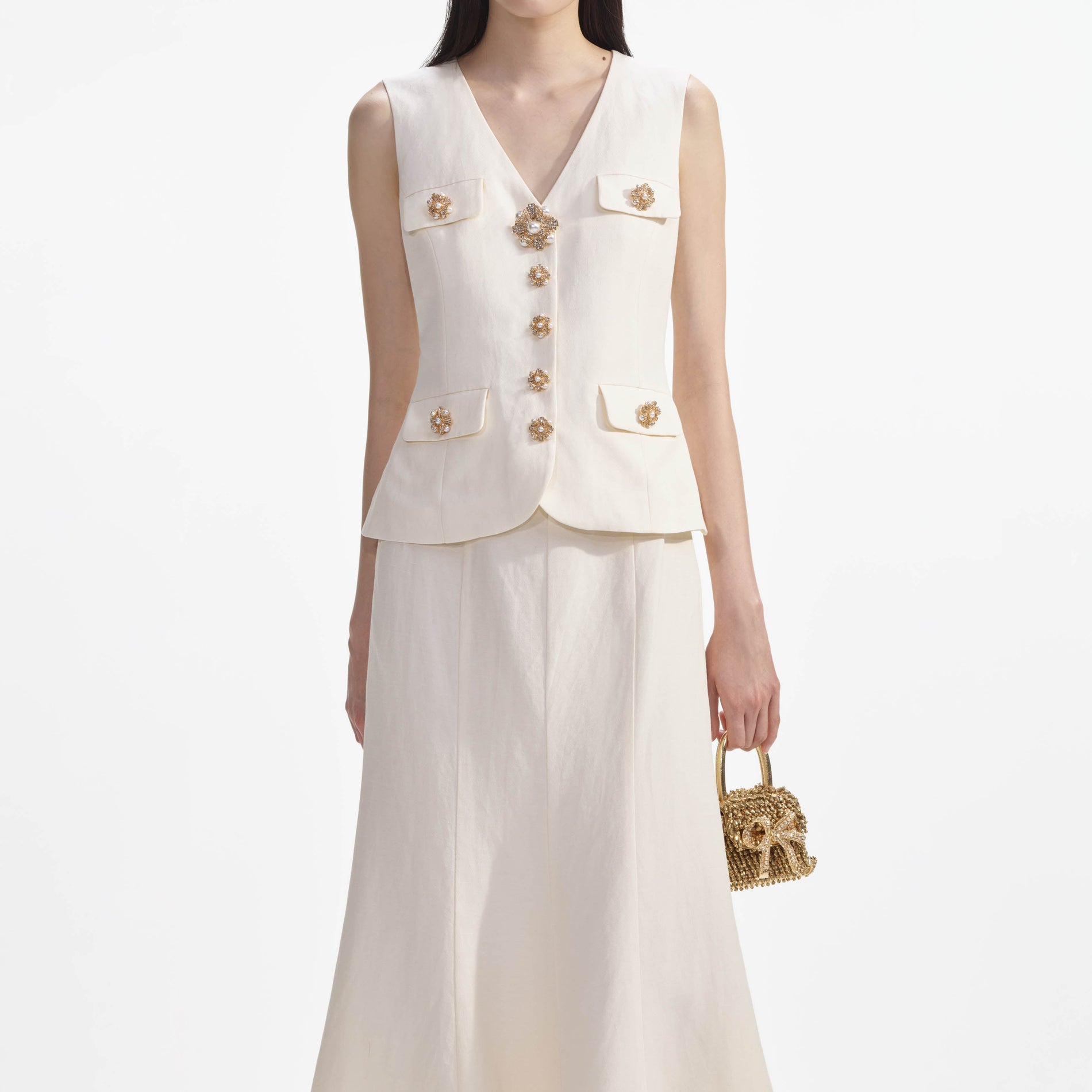 A close up of a woman wearing the Cream Linen Midi Dress