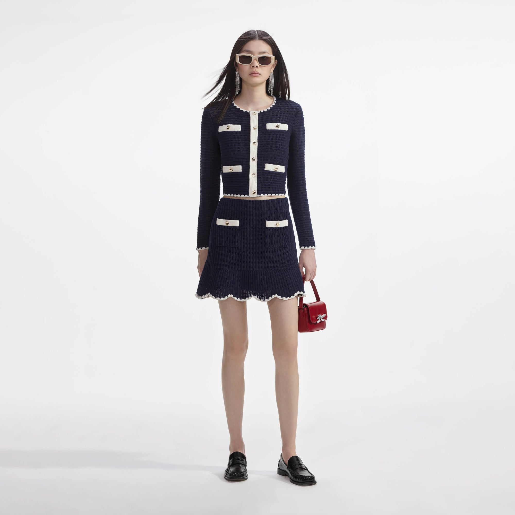 Front view of a woman wearing the Navy Crochet Contrast Trim Mini Skirt