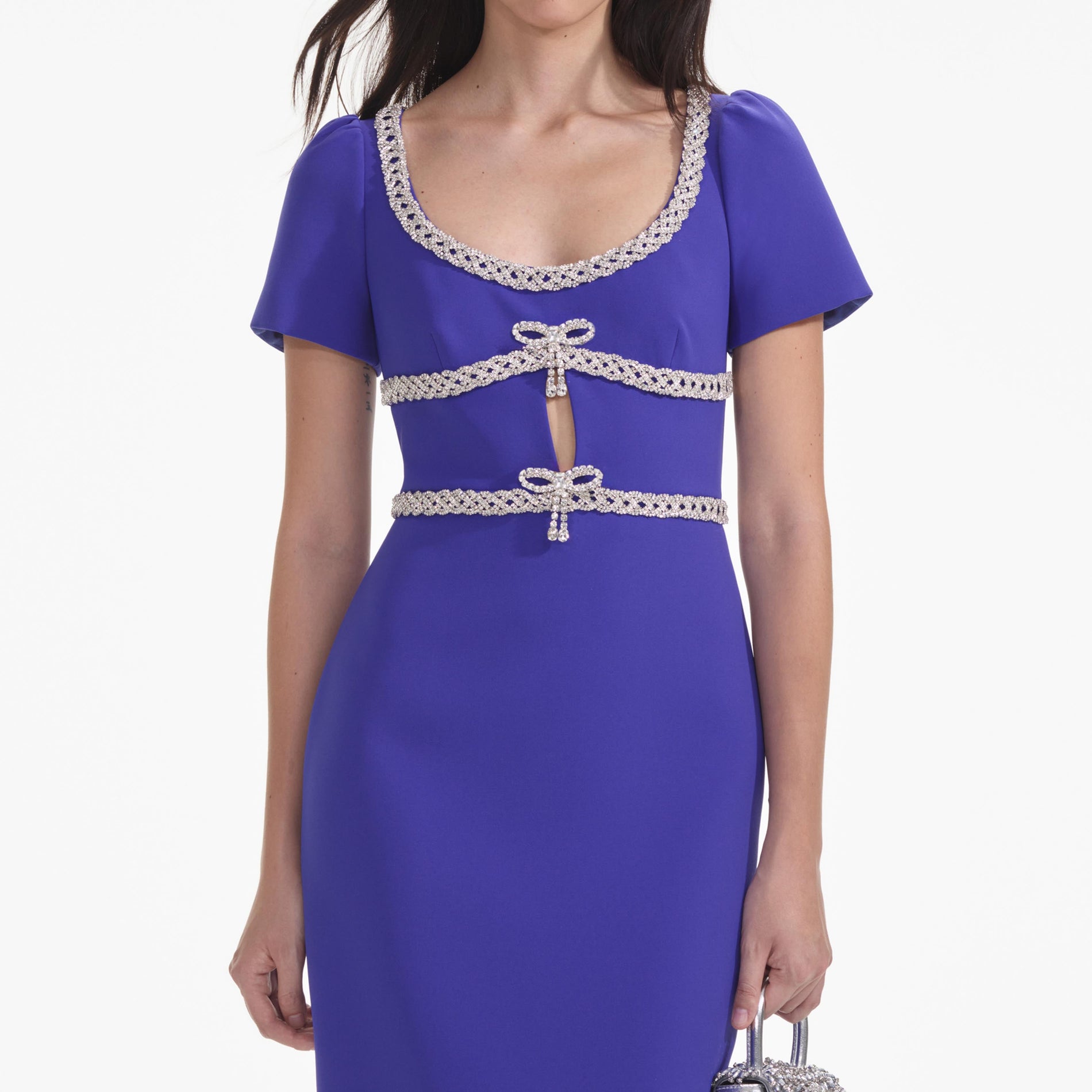 A close up of a woman wearing the Blue Diamante Bow Trim Midi Dress