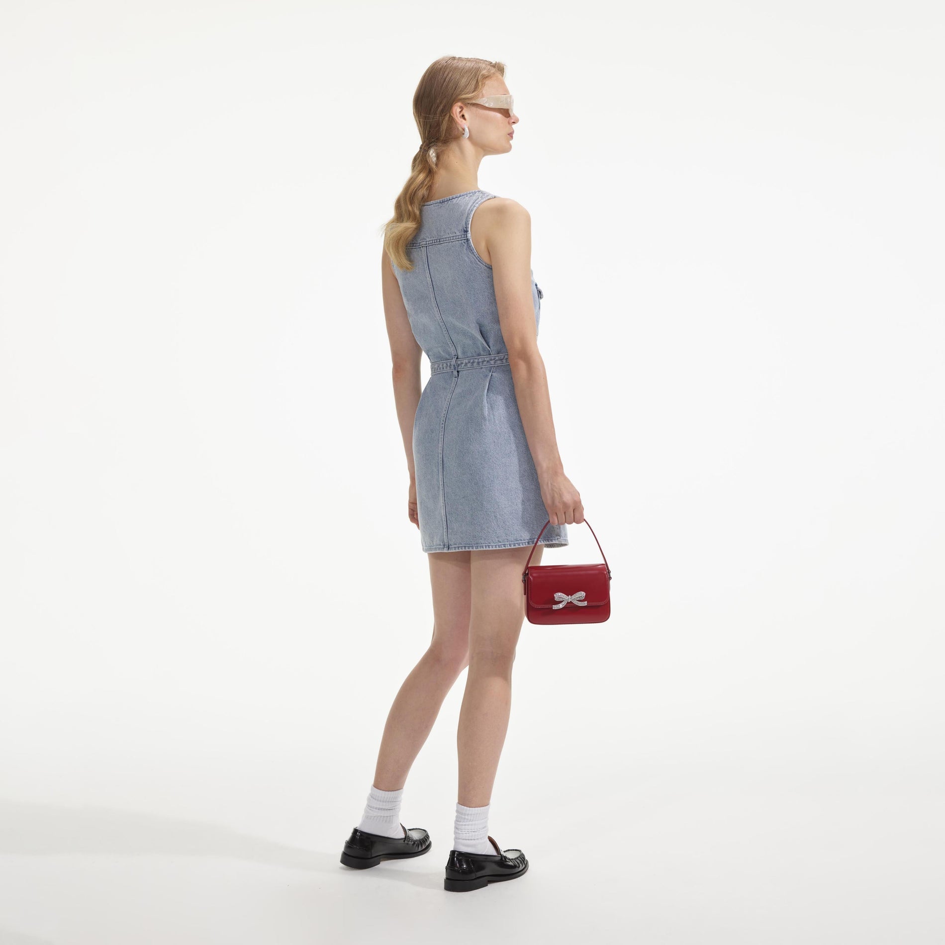 Back view of a woman wearing the Embellished Denim Mini Dress