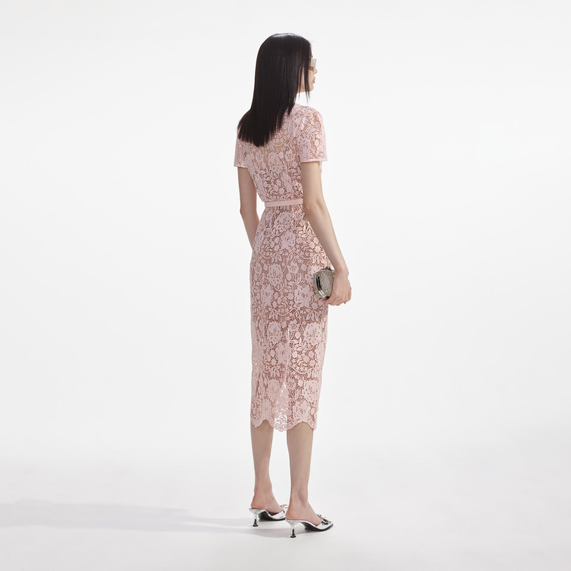 Back view of a woman wearing the Pink Lace Diamante Bow Midi Dress