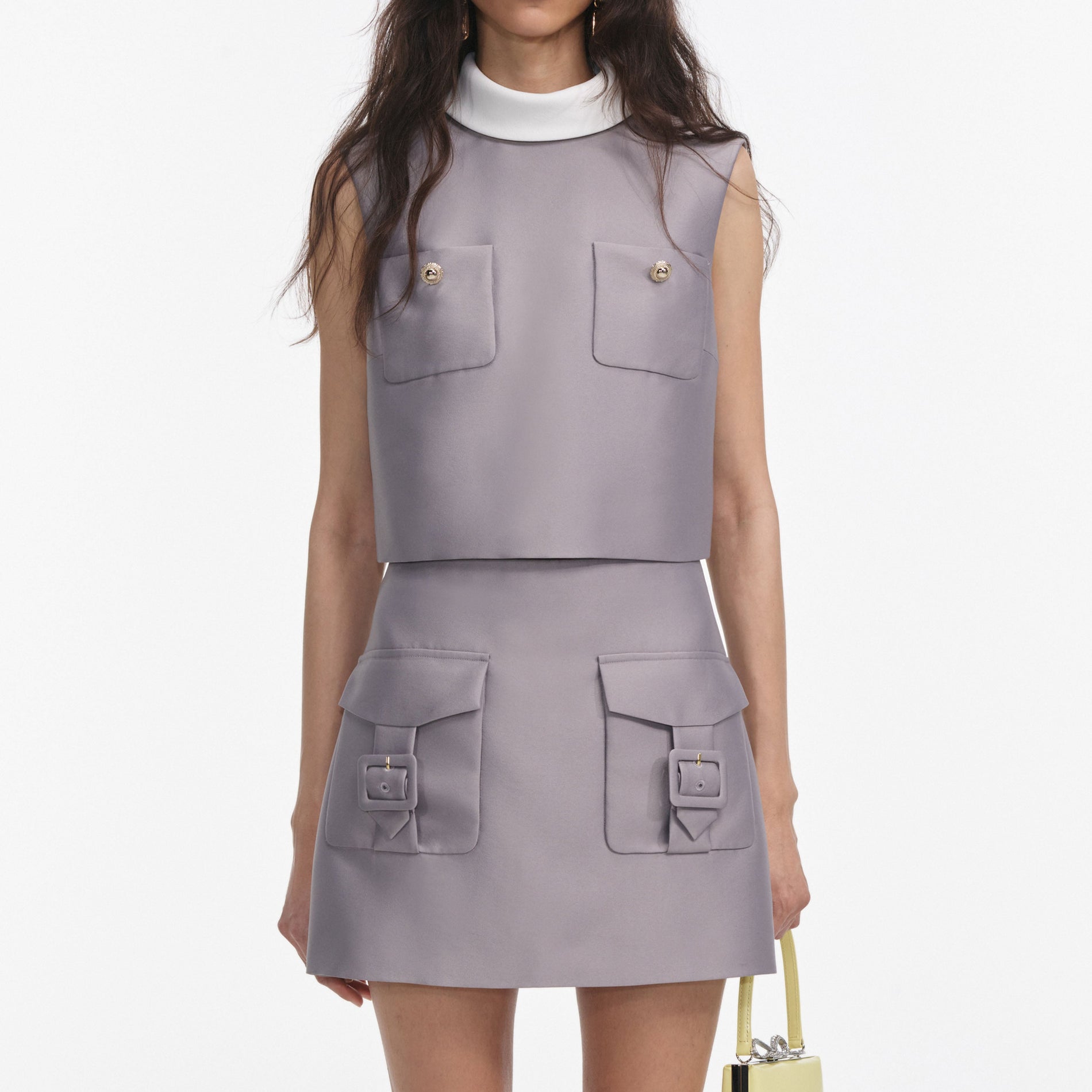 A close up of a woman wearing the Grey Taffeta Mini Skirt