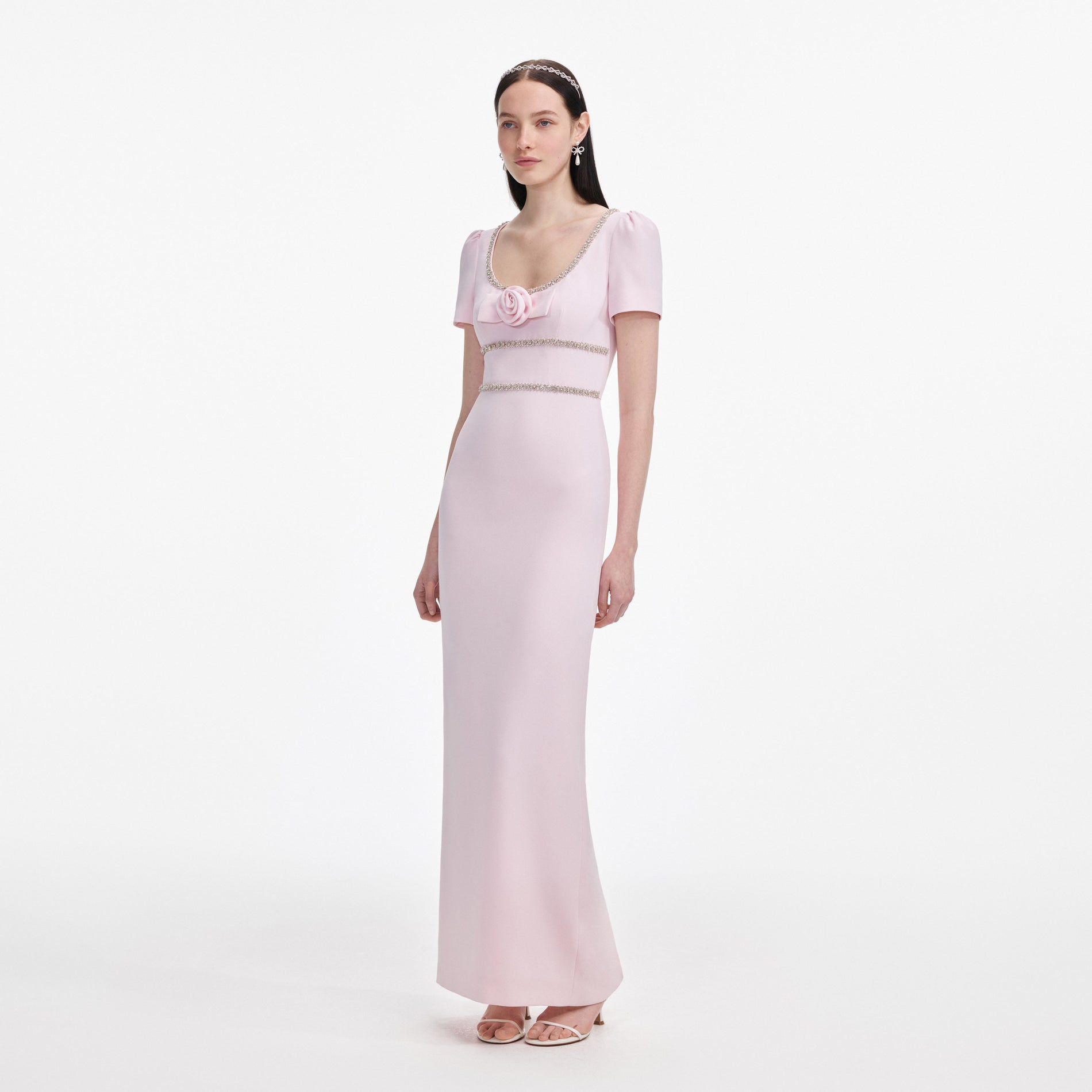 Side view of a woman wearing the Pink Crepe Crystal Trim Maxi Dress