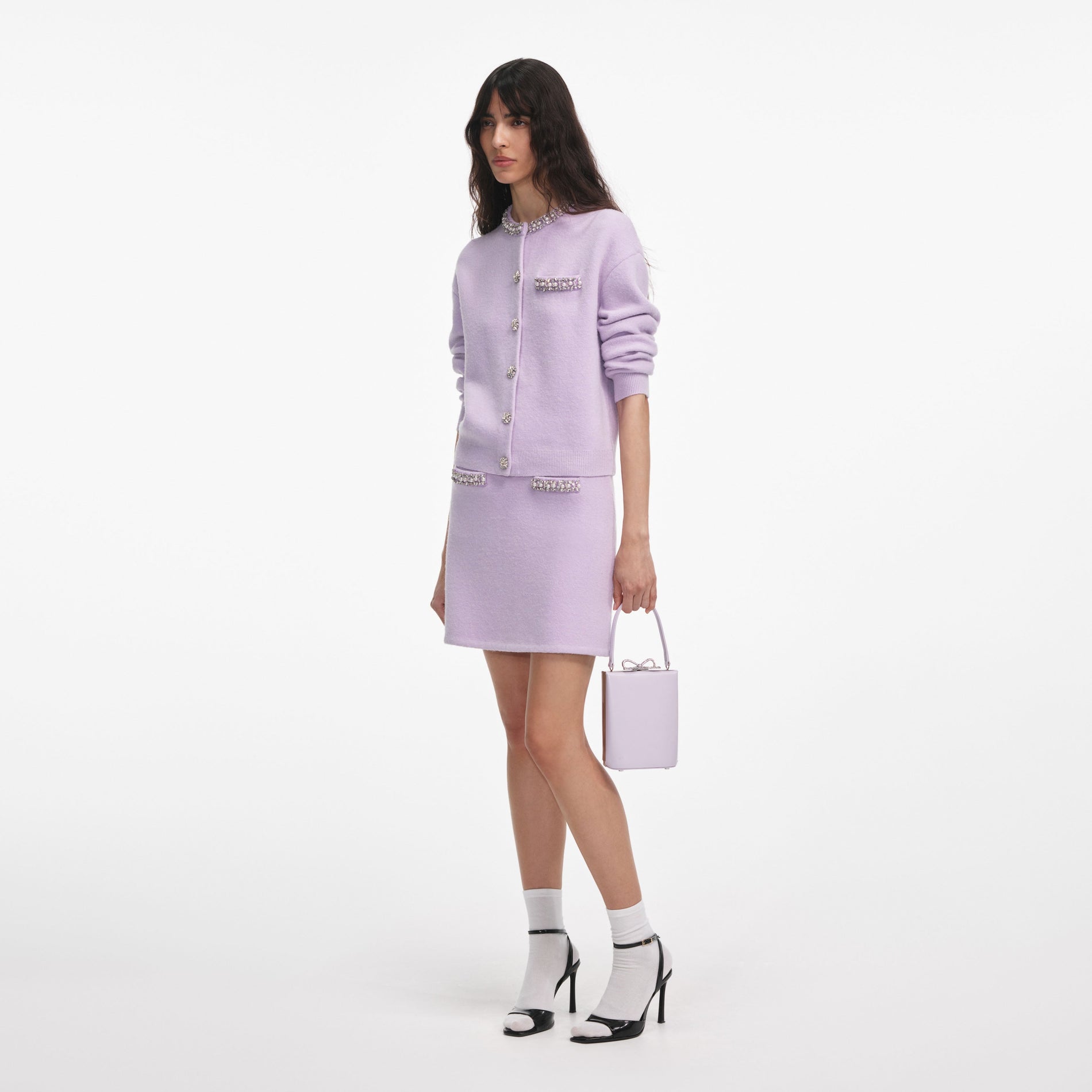 Side view of a woman wearing the Lilac Crystal Trim Knit Skirt