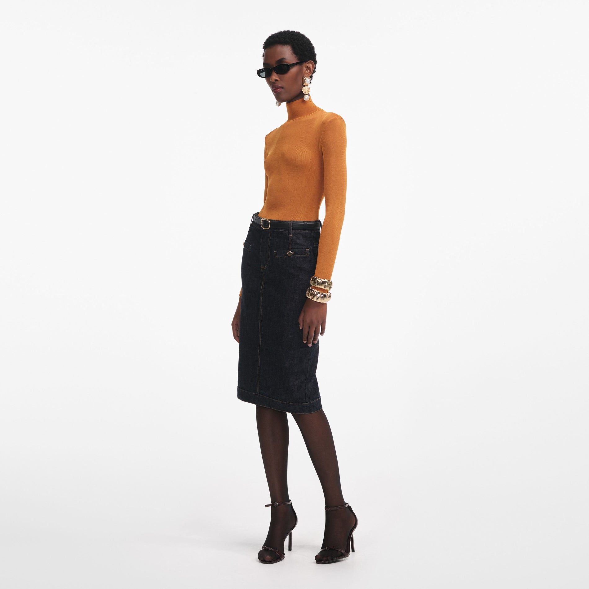 Side view of a woman wearing the Burnt Orange Viscose Knit Top