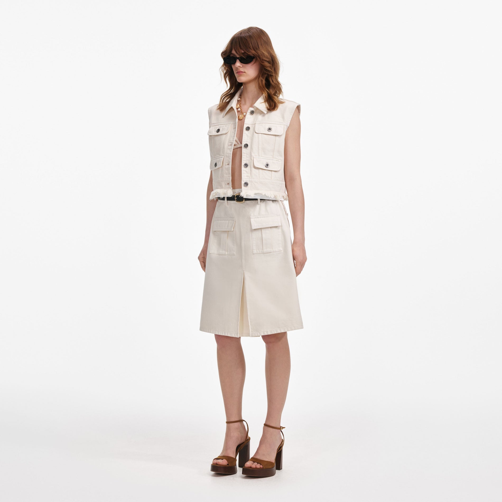 Side view of a woman wearing the Cream Denim Sleeveless Top