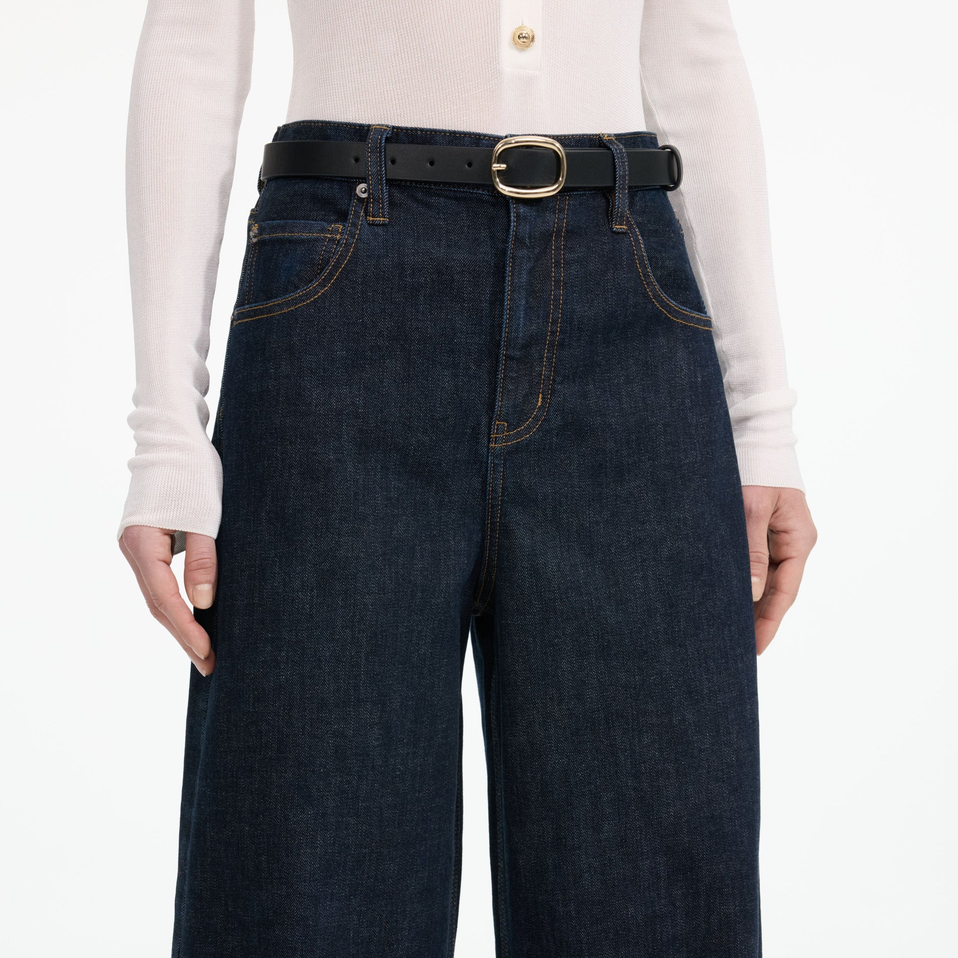 A close up of a woman wearing the Indigo Barrel Leg Jeans